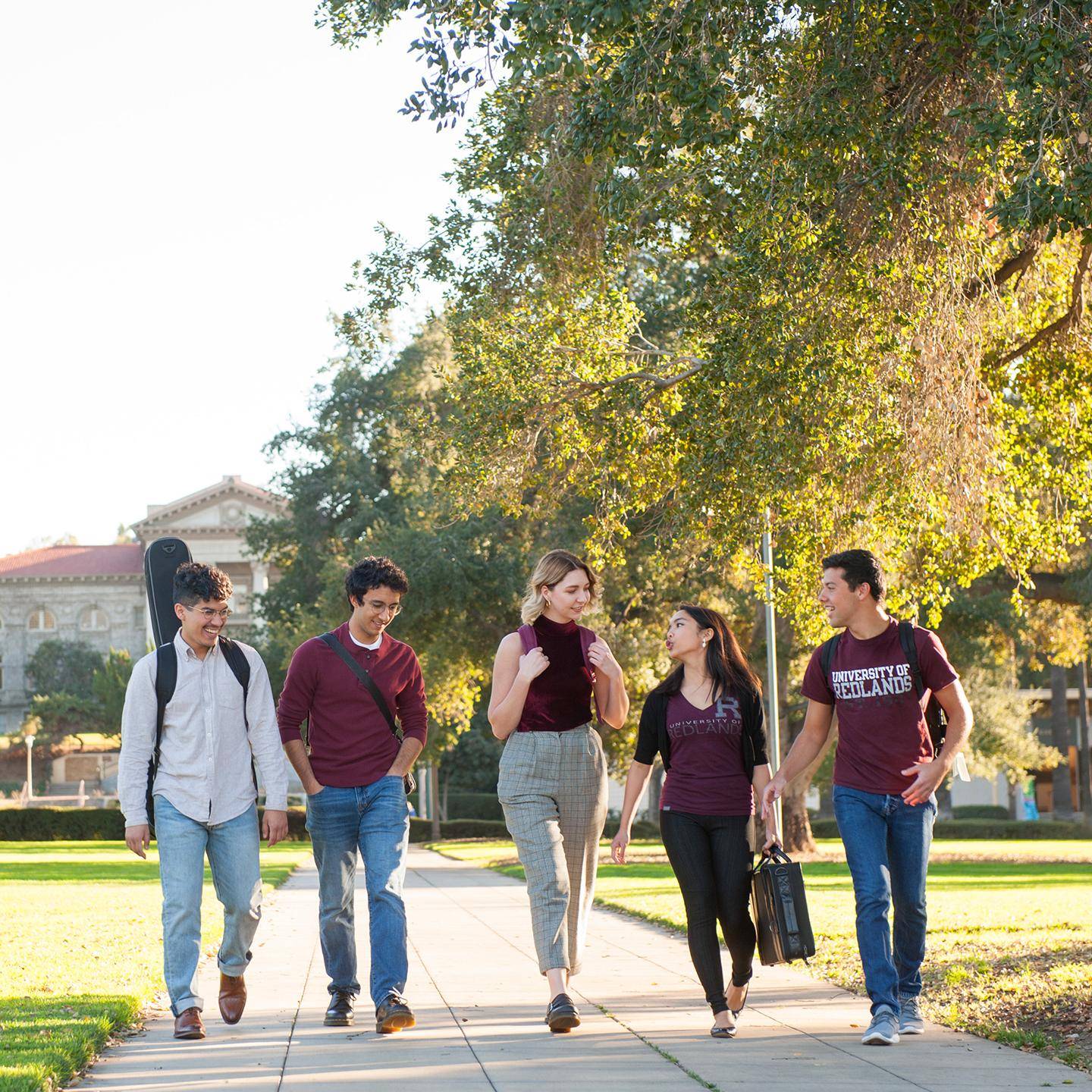 a group of people walking on a sidewalk