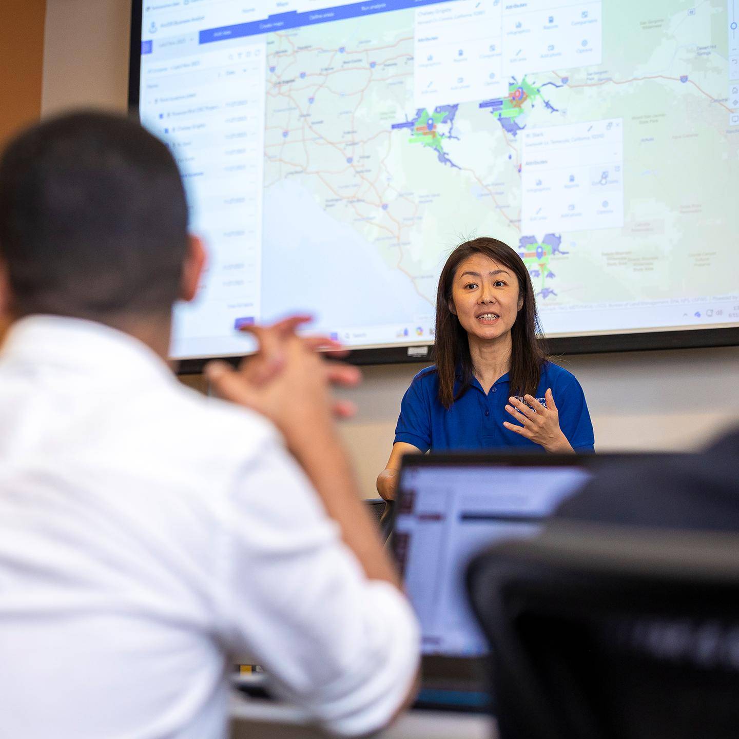 a person in front of a large screen