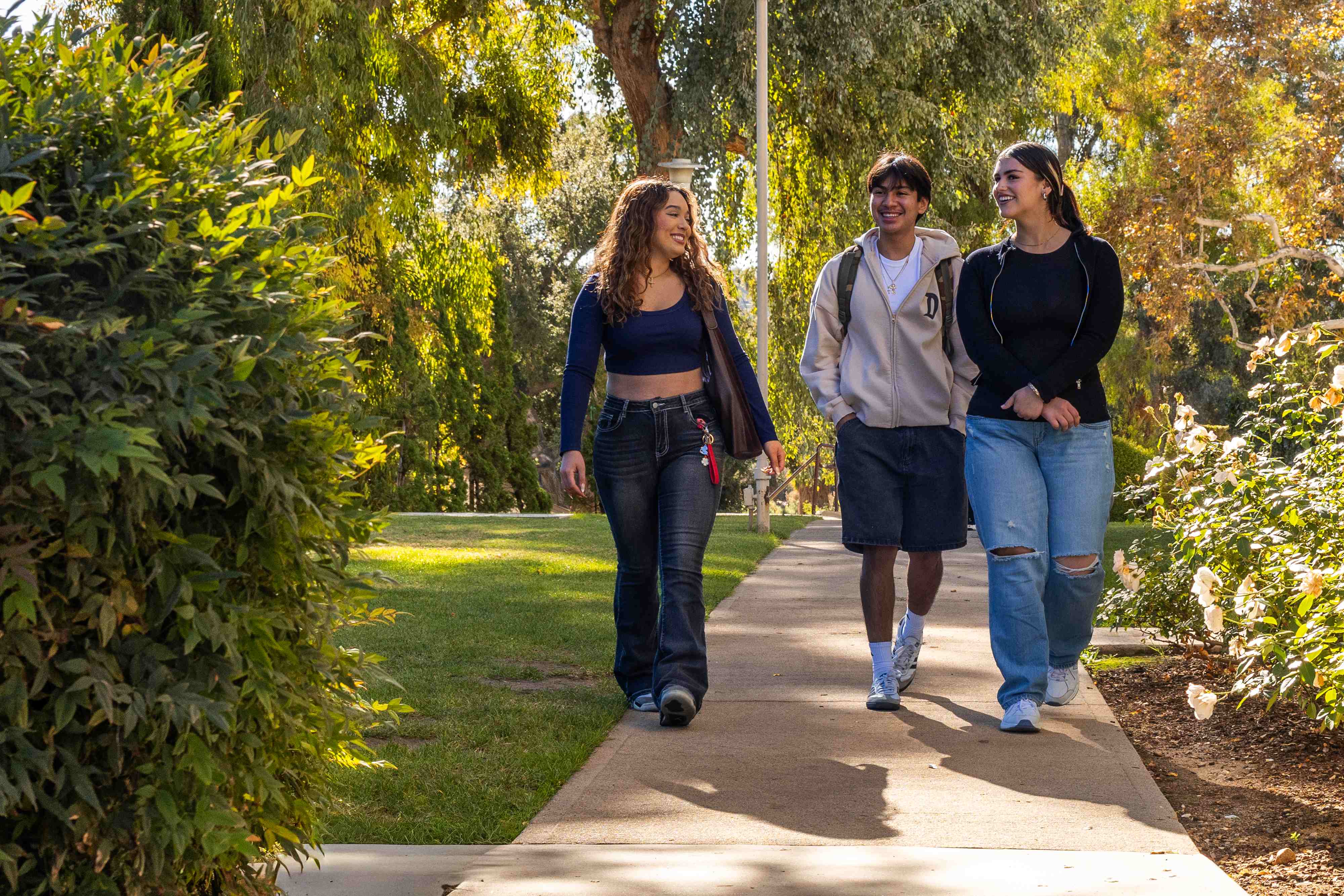 a group of people walking on a sidewalk
