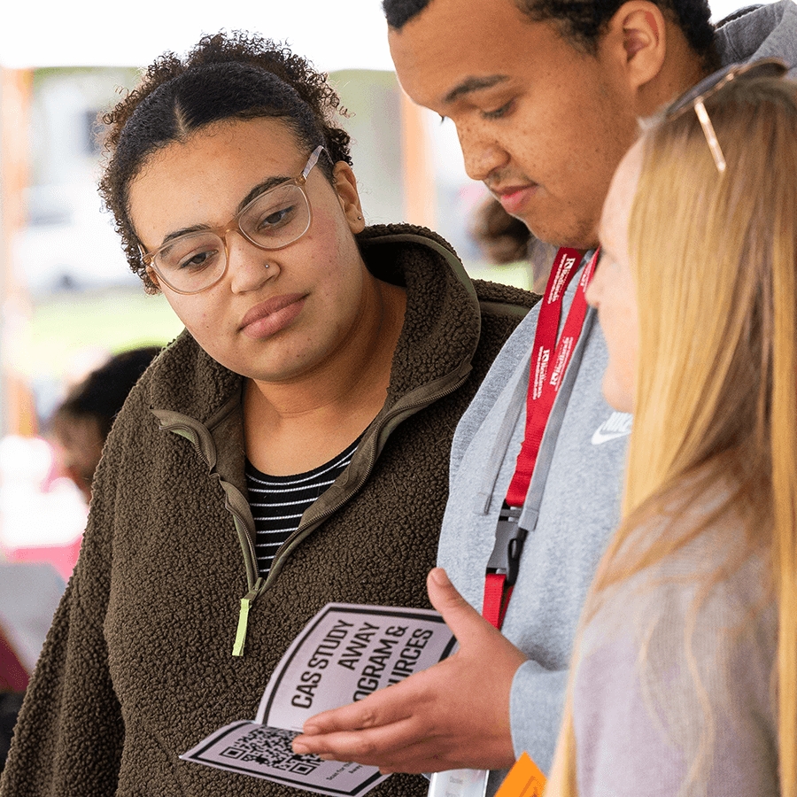 a group of people looking at a card