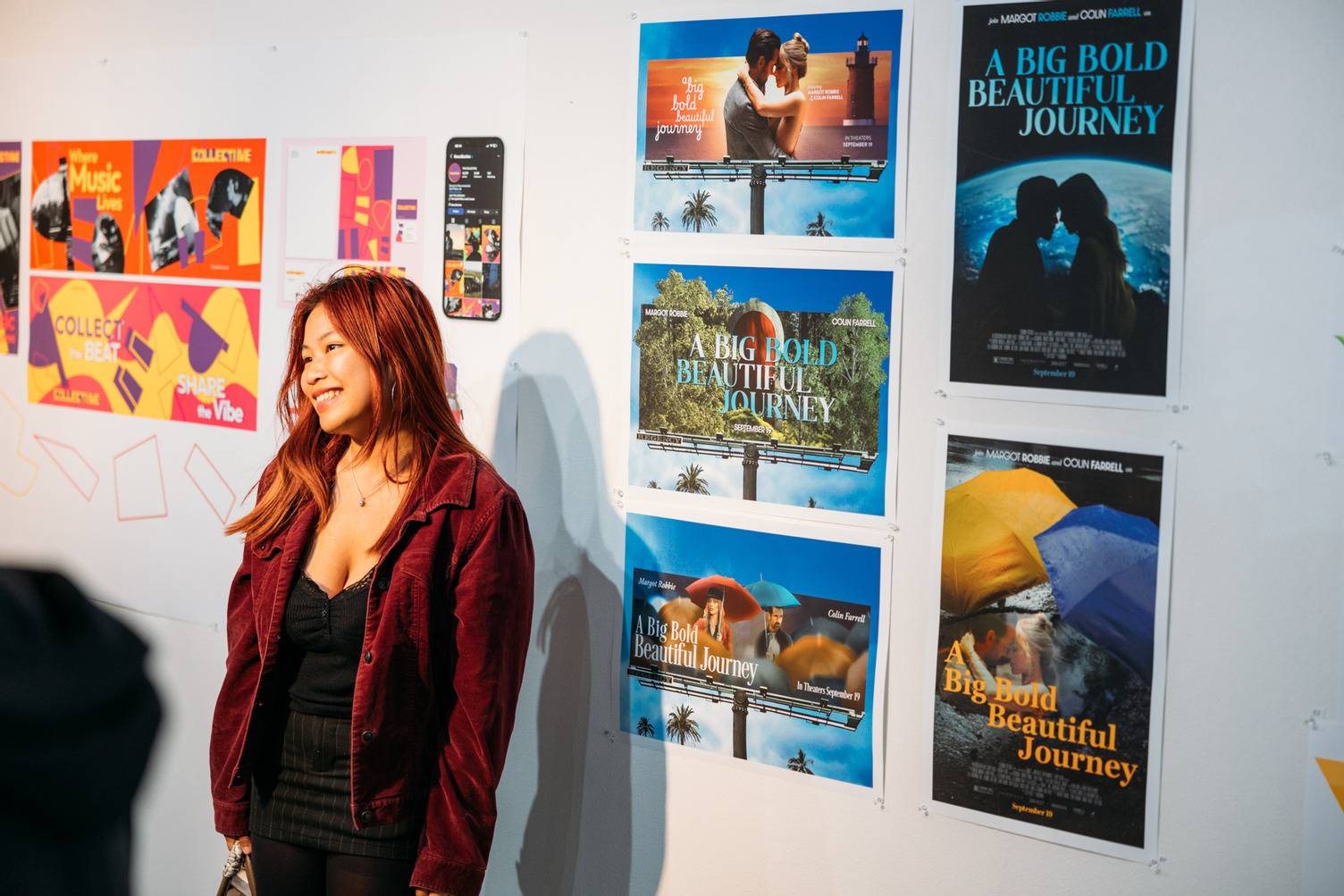 a person standing next to a wall with posters