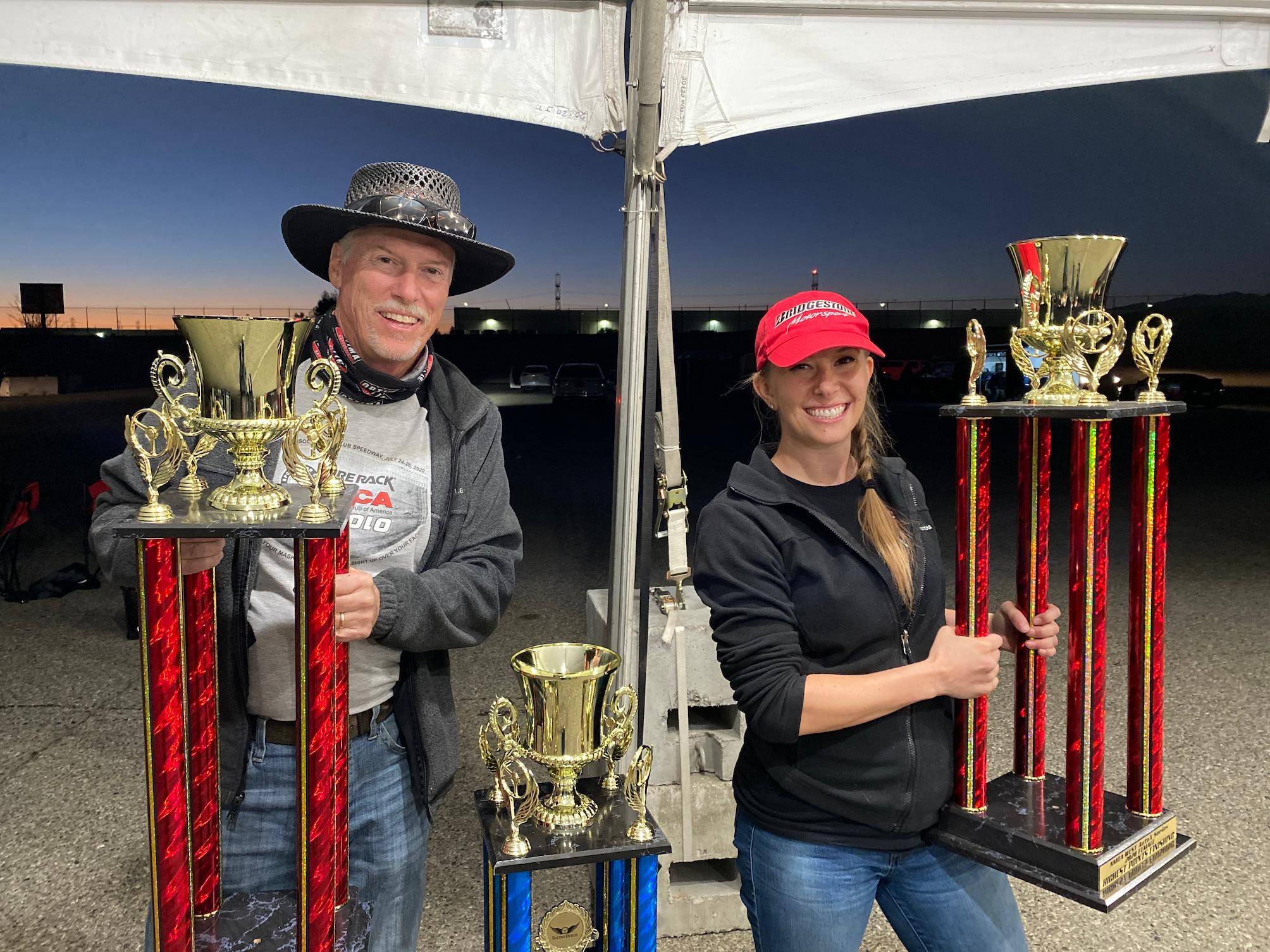 a person and person holding trophies