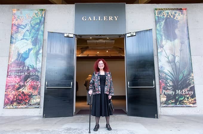 a person standing in front of a gallery