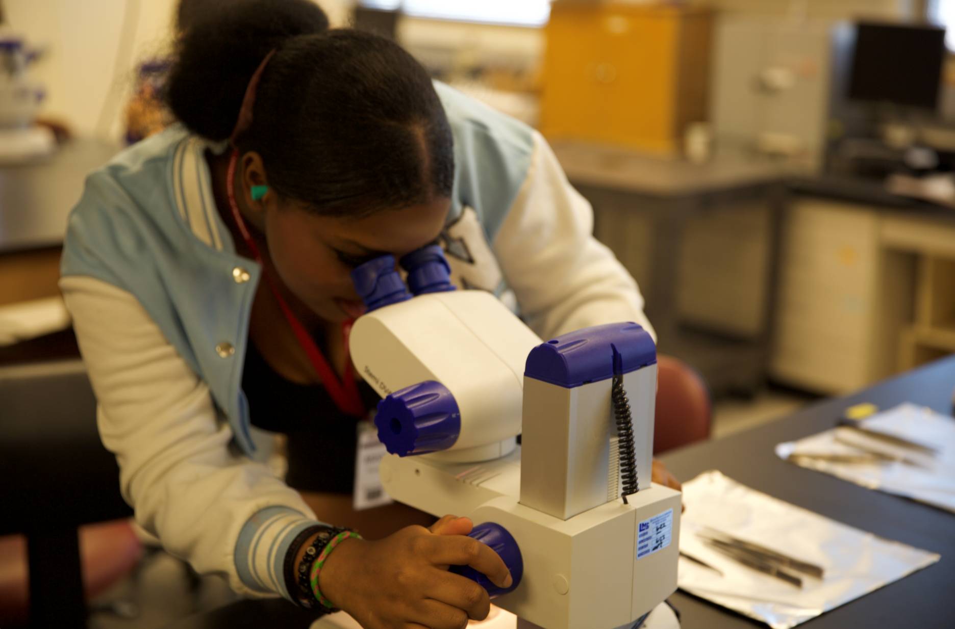 a person looking through a microscope