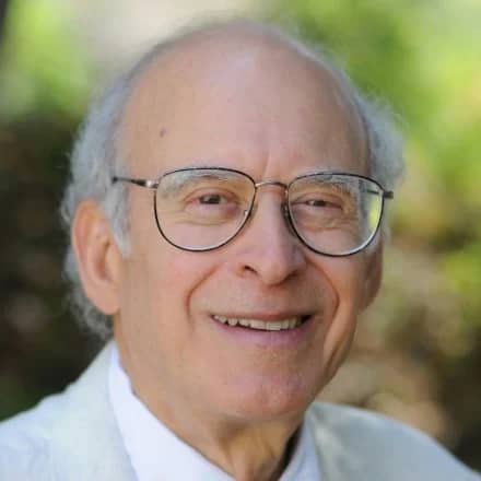 a person wearing glasses smiling