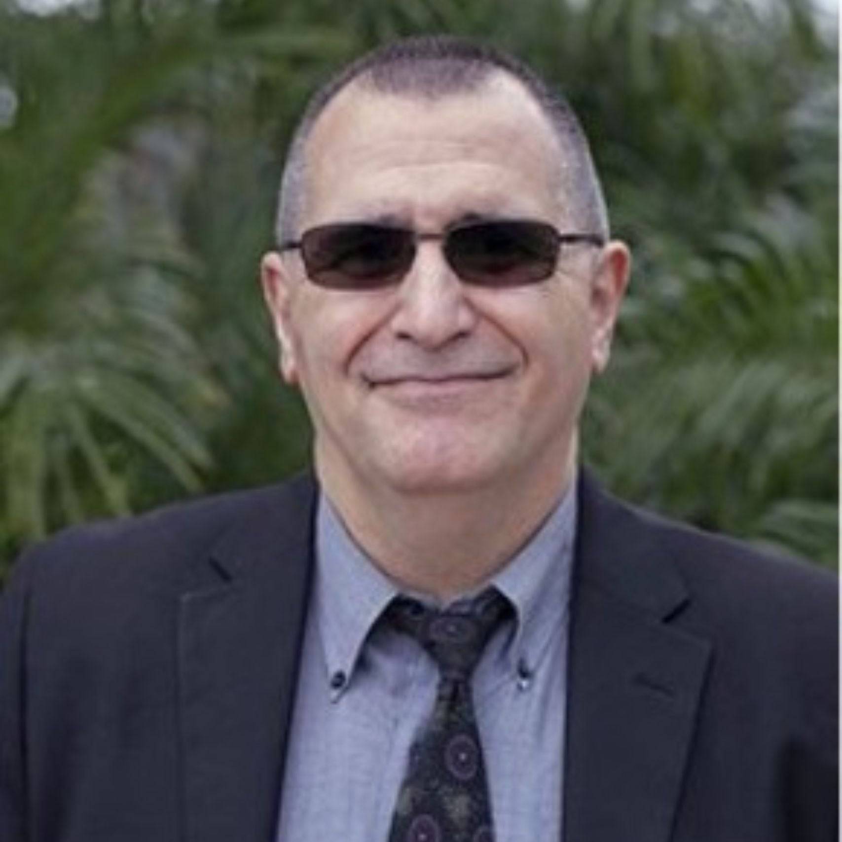 a person wearing sunglasses and a suit