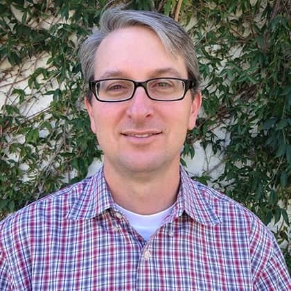 a person wearing glasses and a plaid shirt