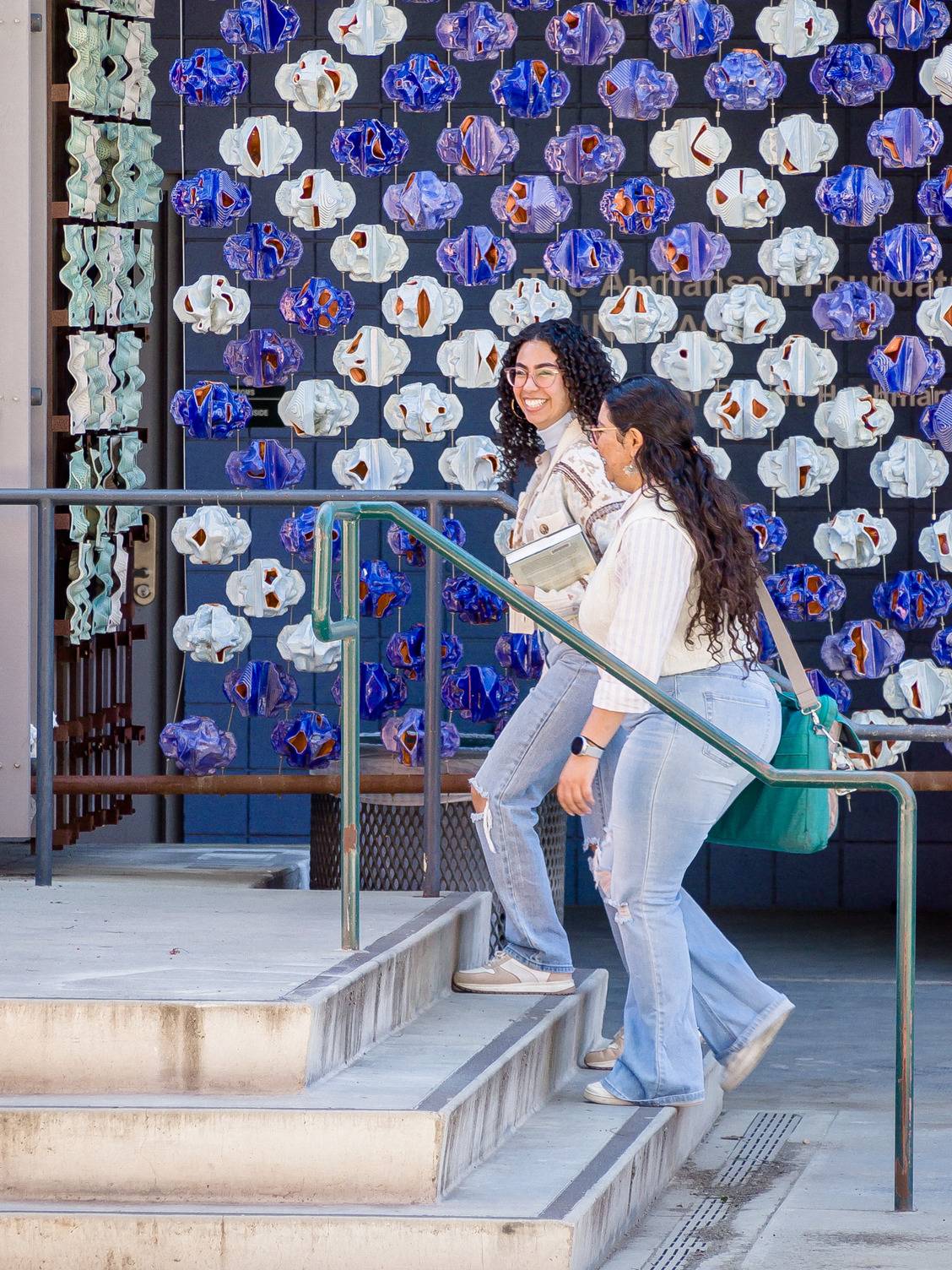two women walking up stairs