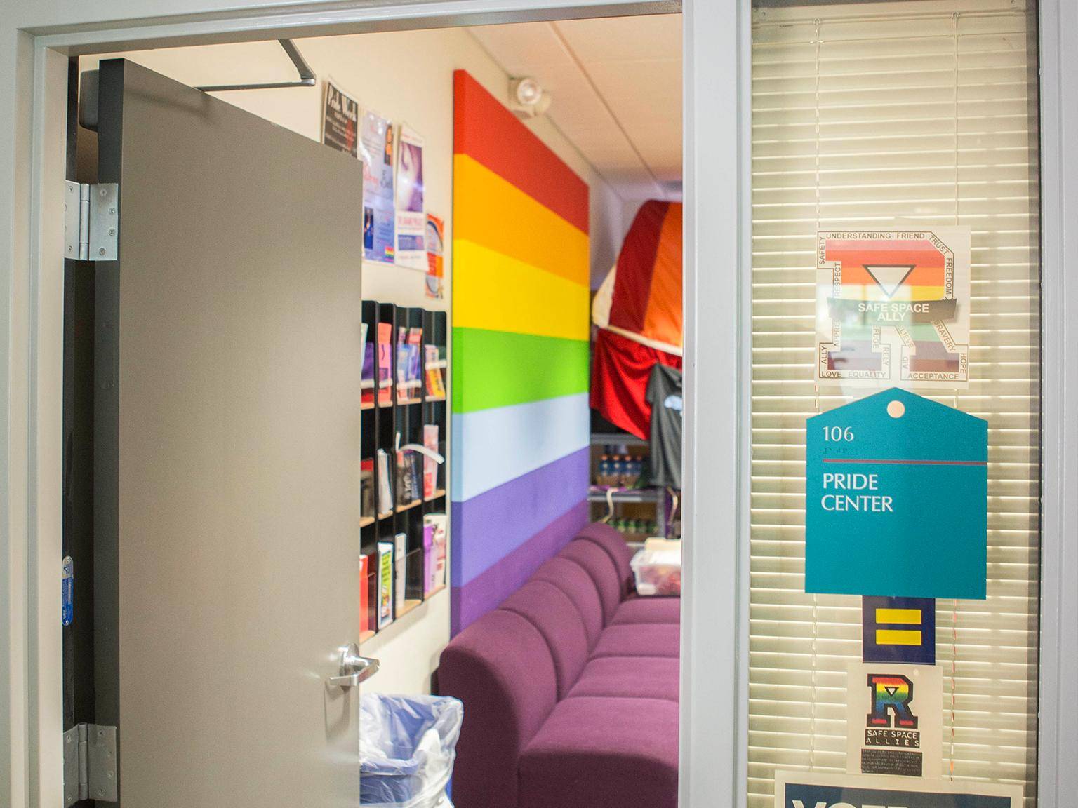 a door open to a room with a rainbow wall