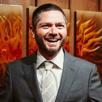 a person in a suit smiling