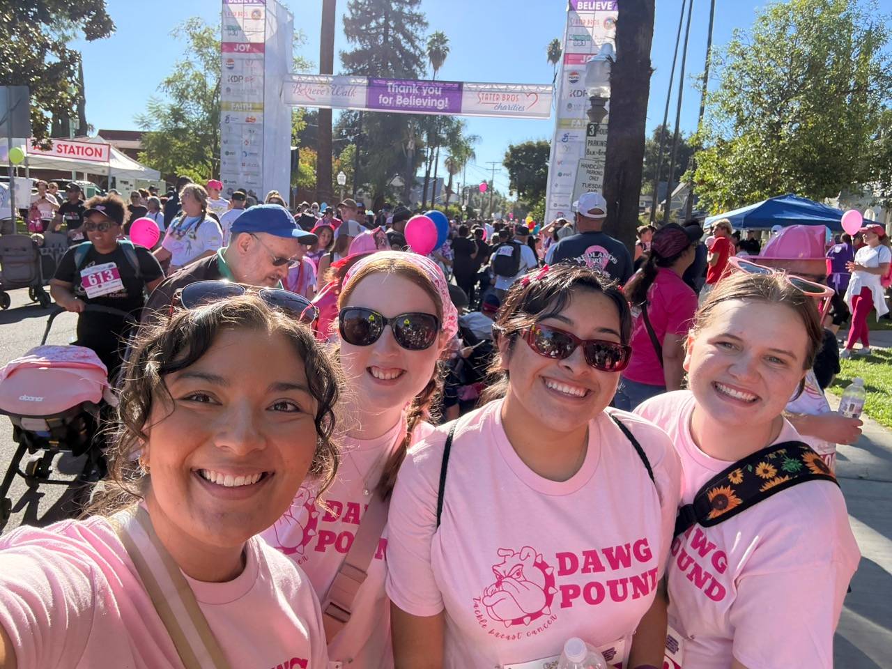 a group of women wearing pink shirts