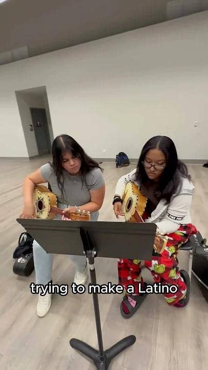 a couple of women playing guitars