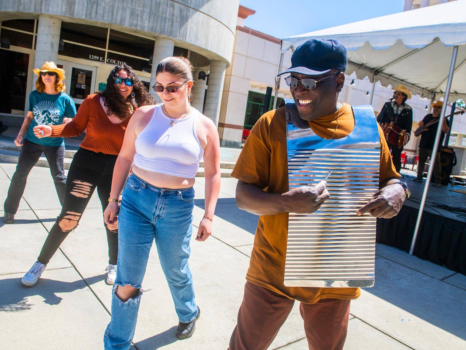 a person in a blue hat and sunglasses with a silver object on it