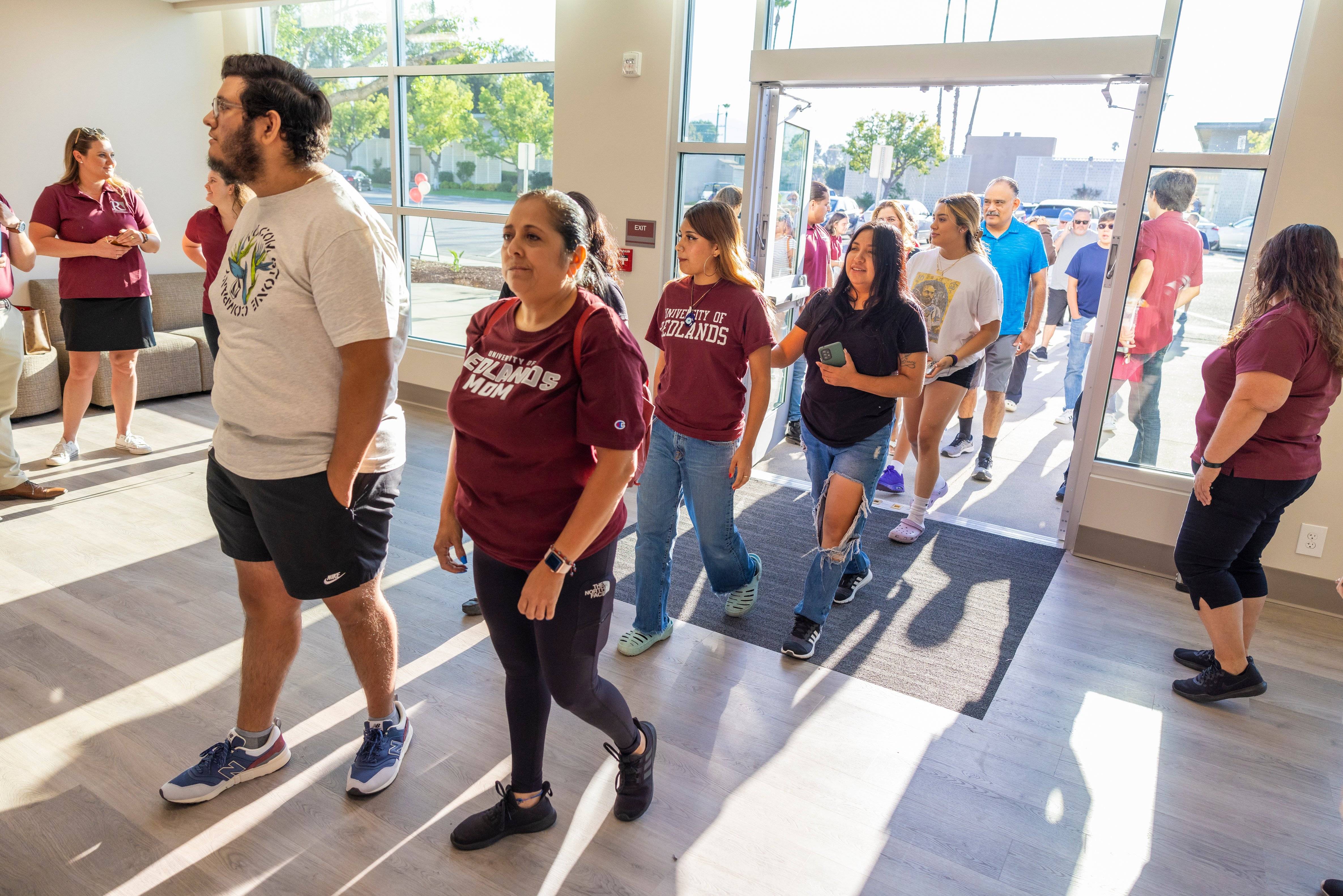 a group of people walking in a hallway