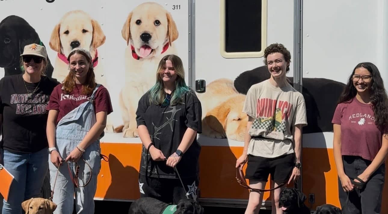 a group of people standing in front of a trailer