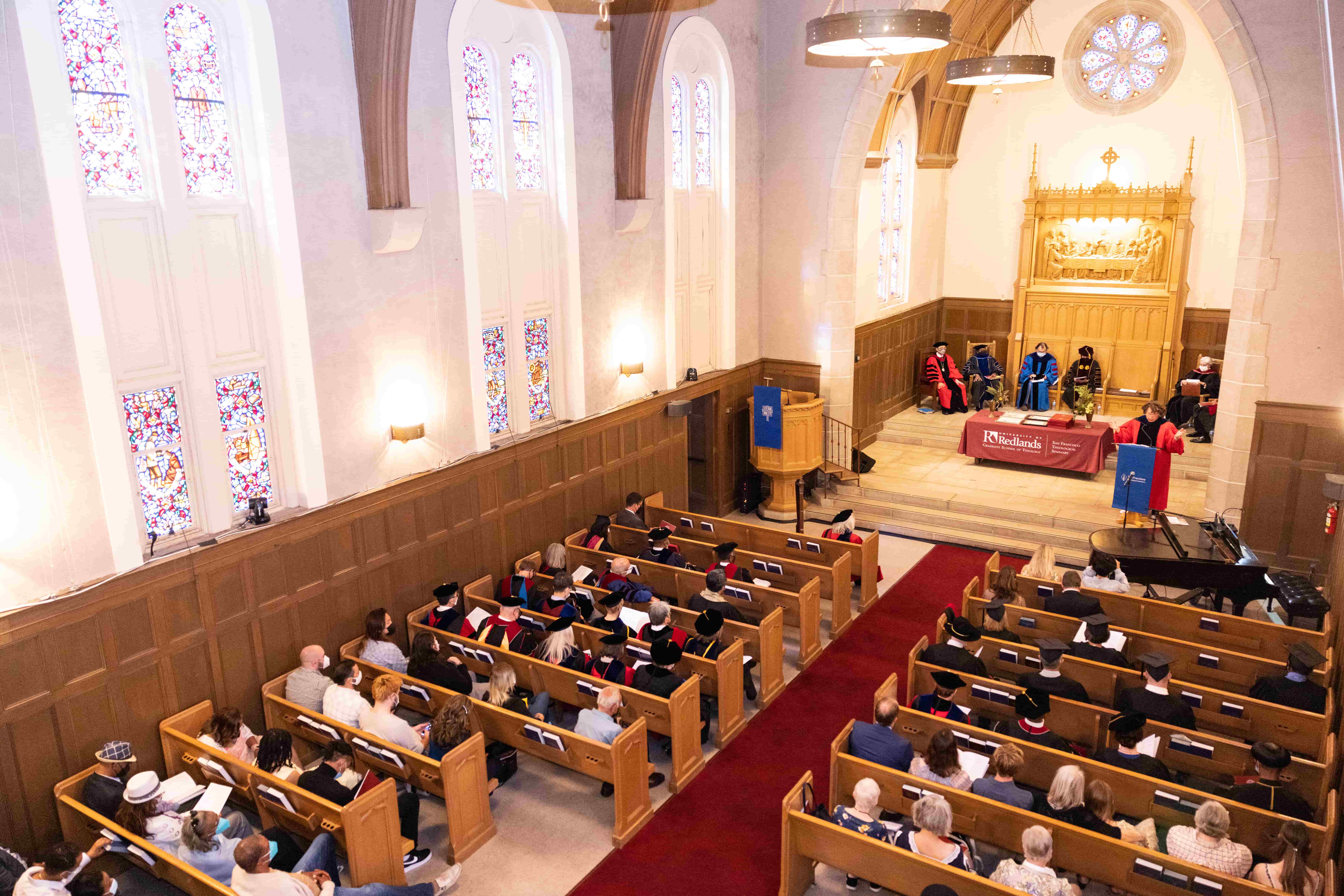 a group of people sitting in pews in a church