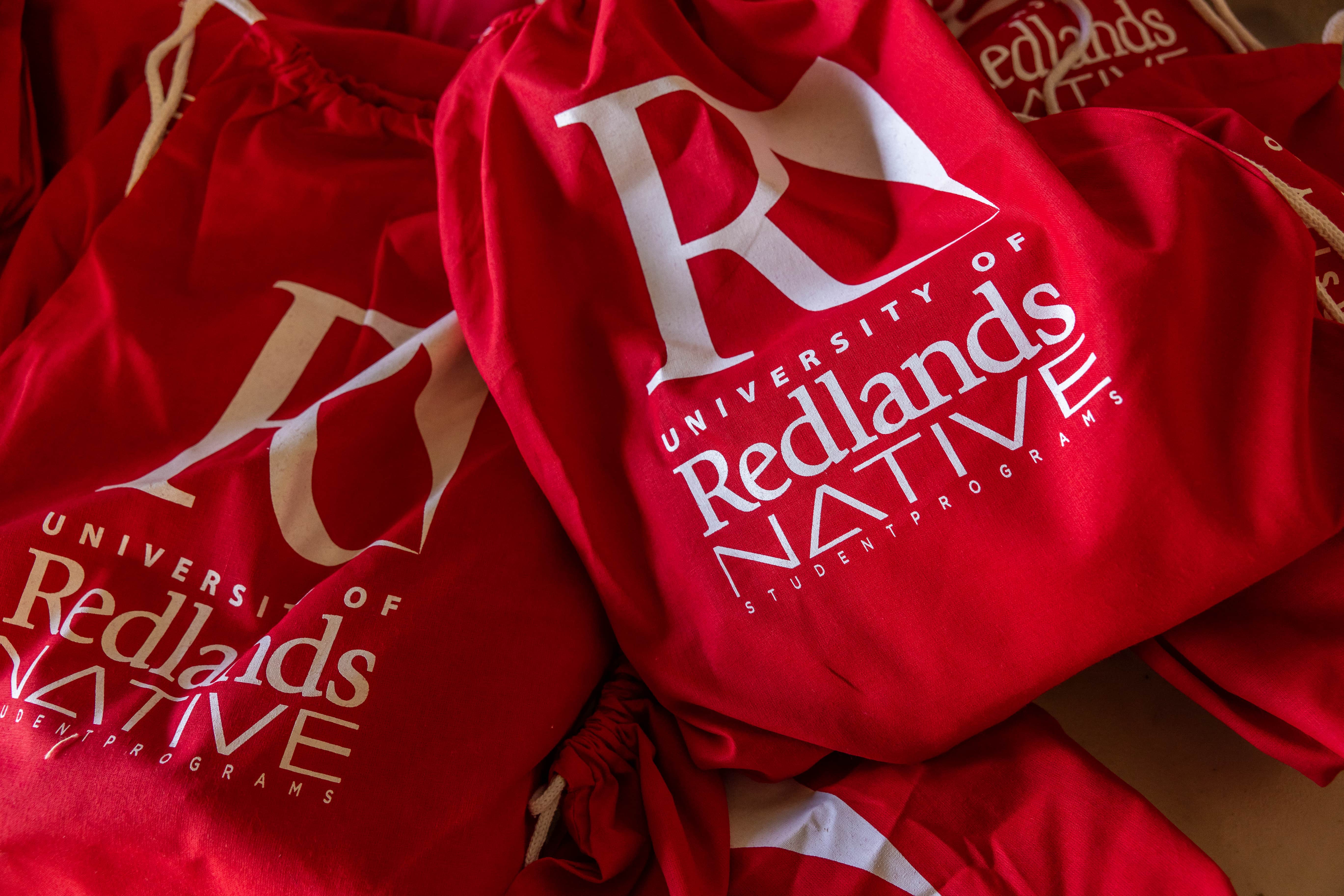 a pile of red bags with white text