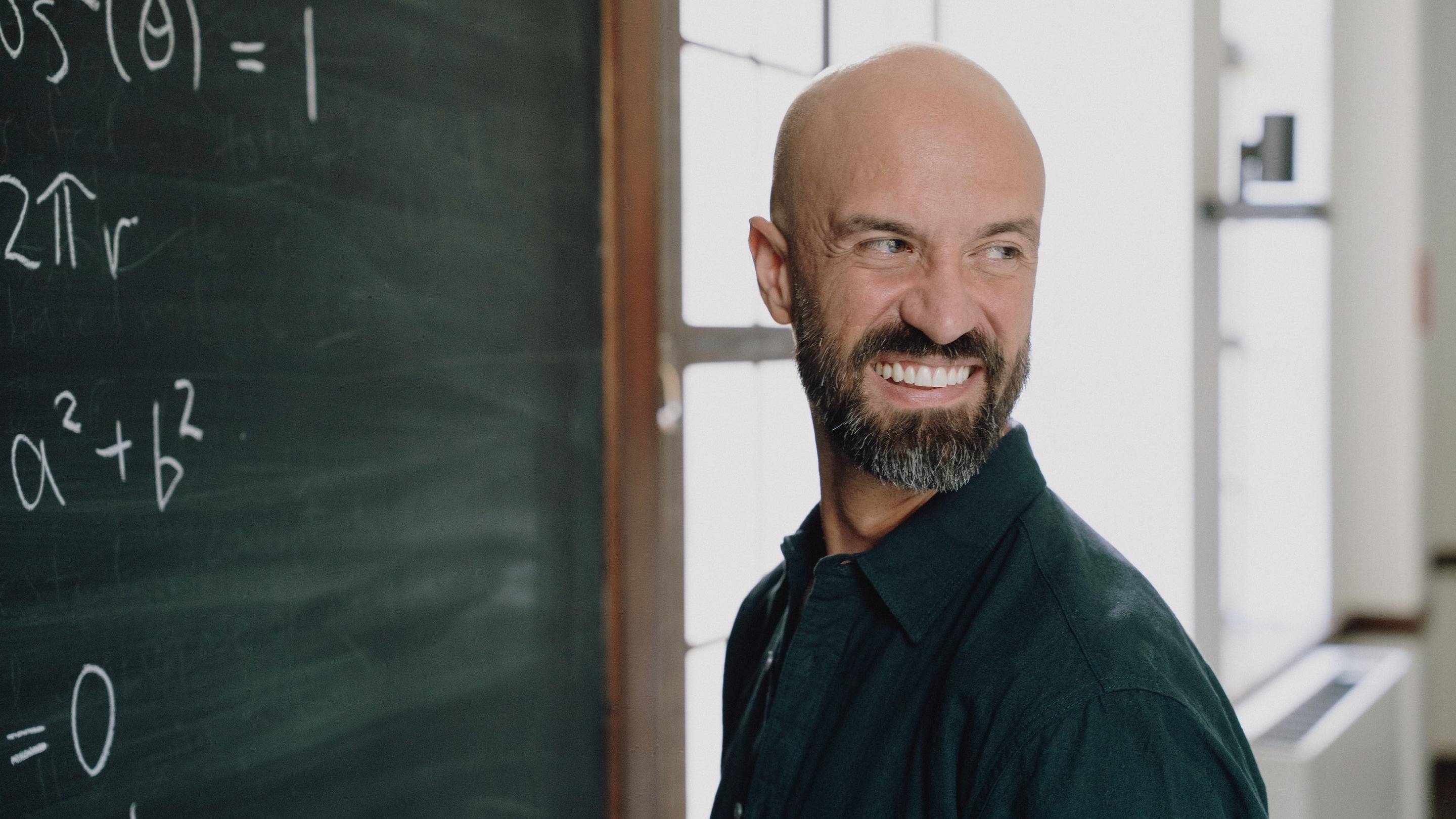 a person smiling with a beard