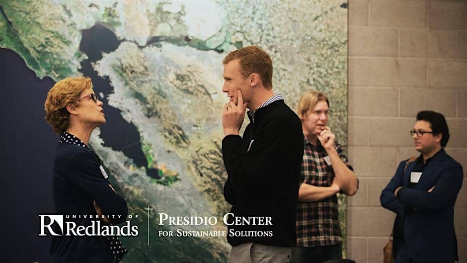 a group of men standing in front of a map