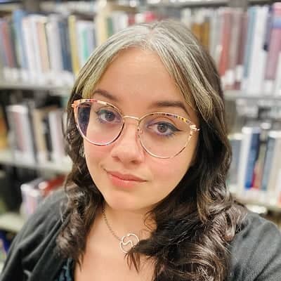 a person wearing glasses in a library