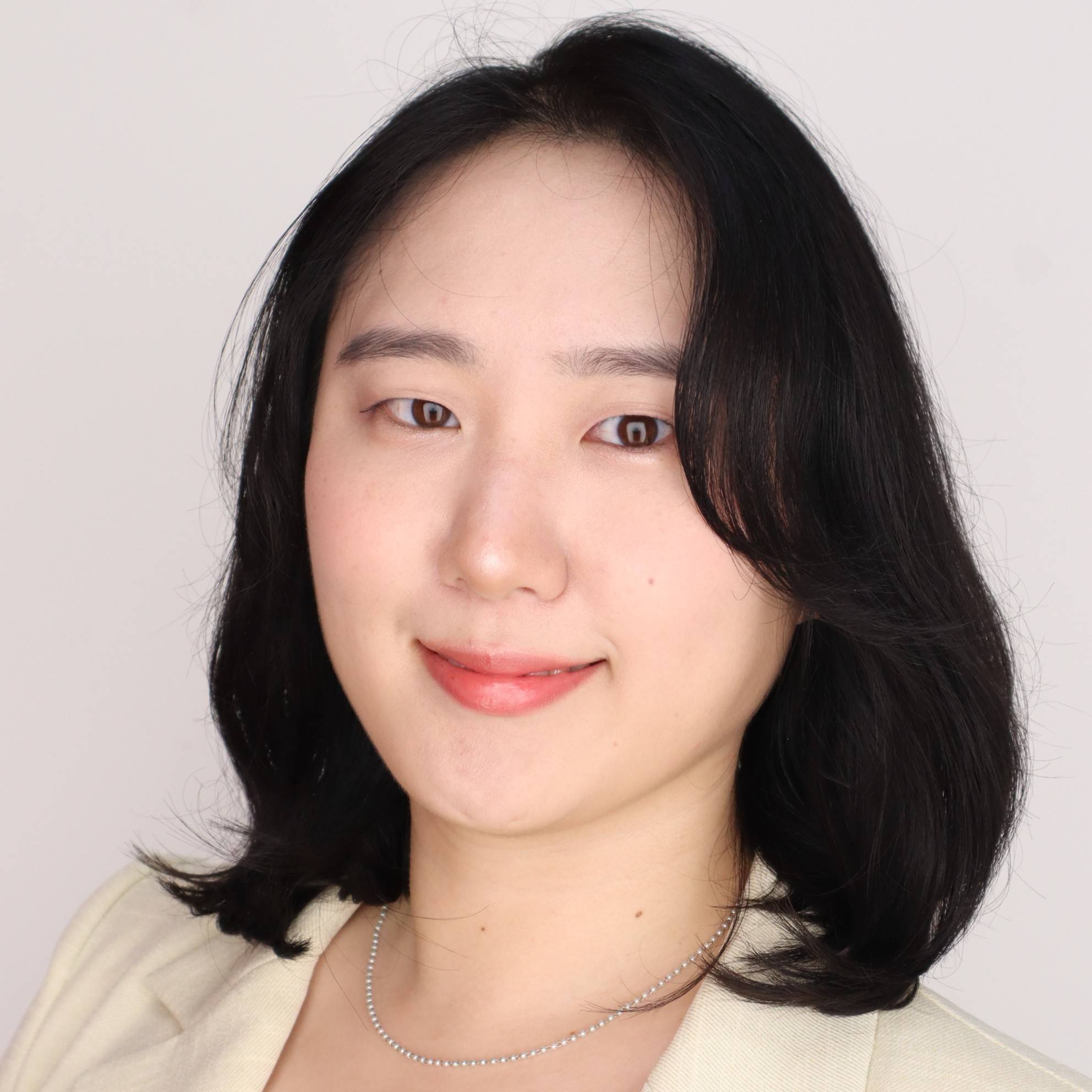 a person with dark hair wearing a white shirt