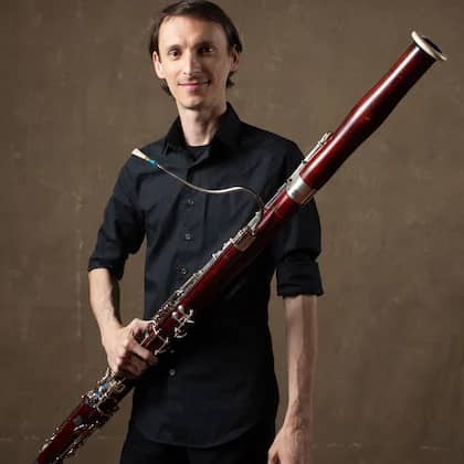 a person holding a bassoon