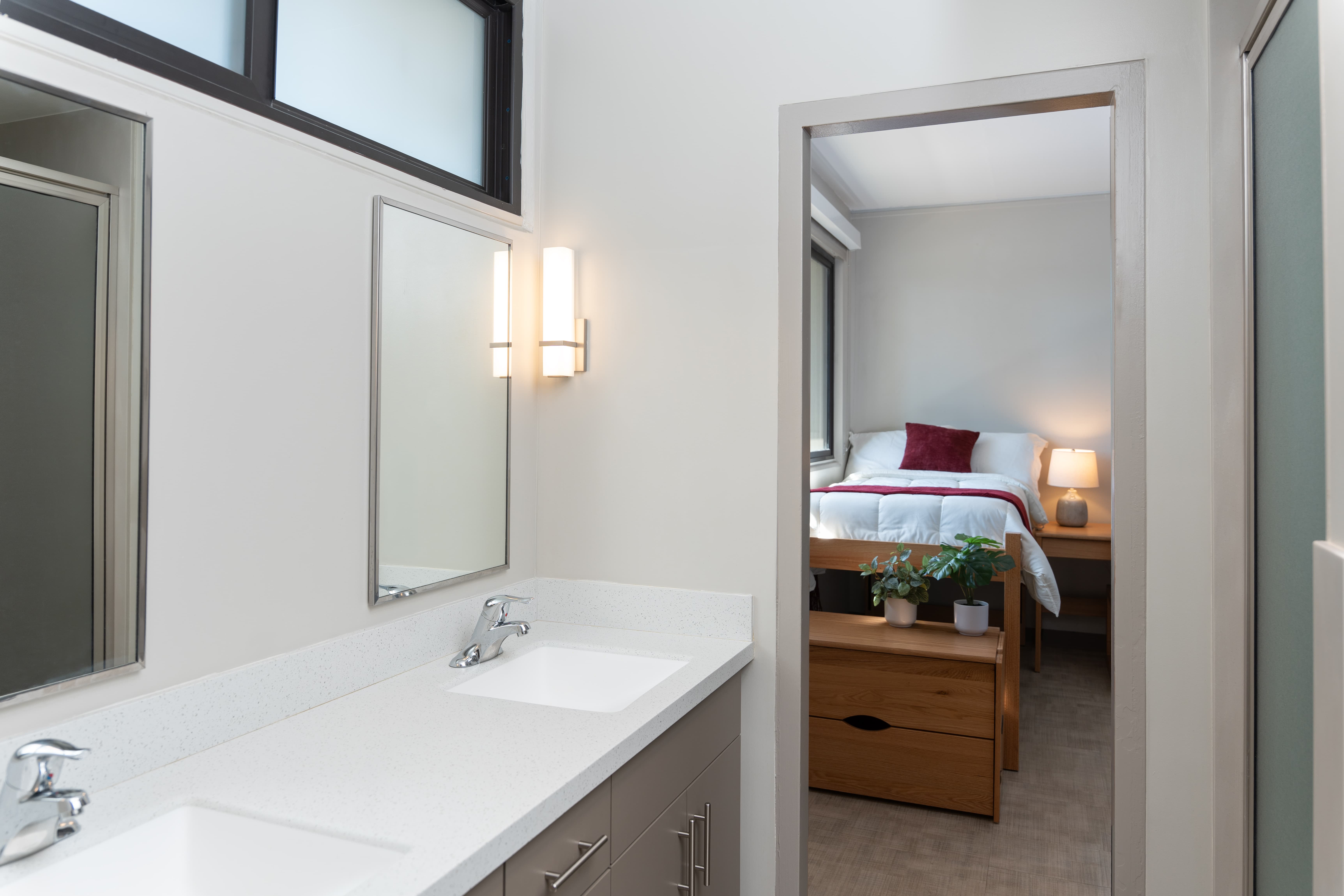 a bathroom with a mirror and a bed