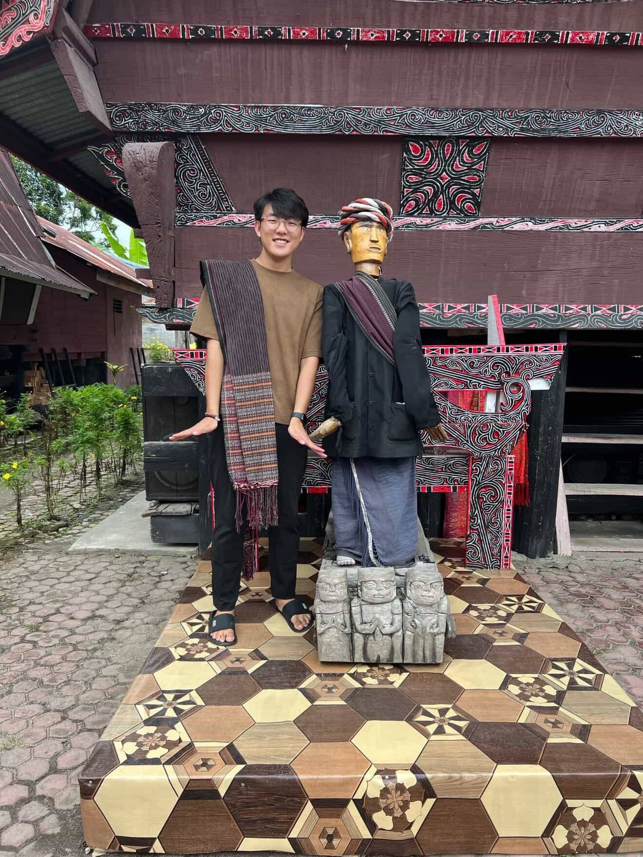 a person standing next to a statue