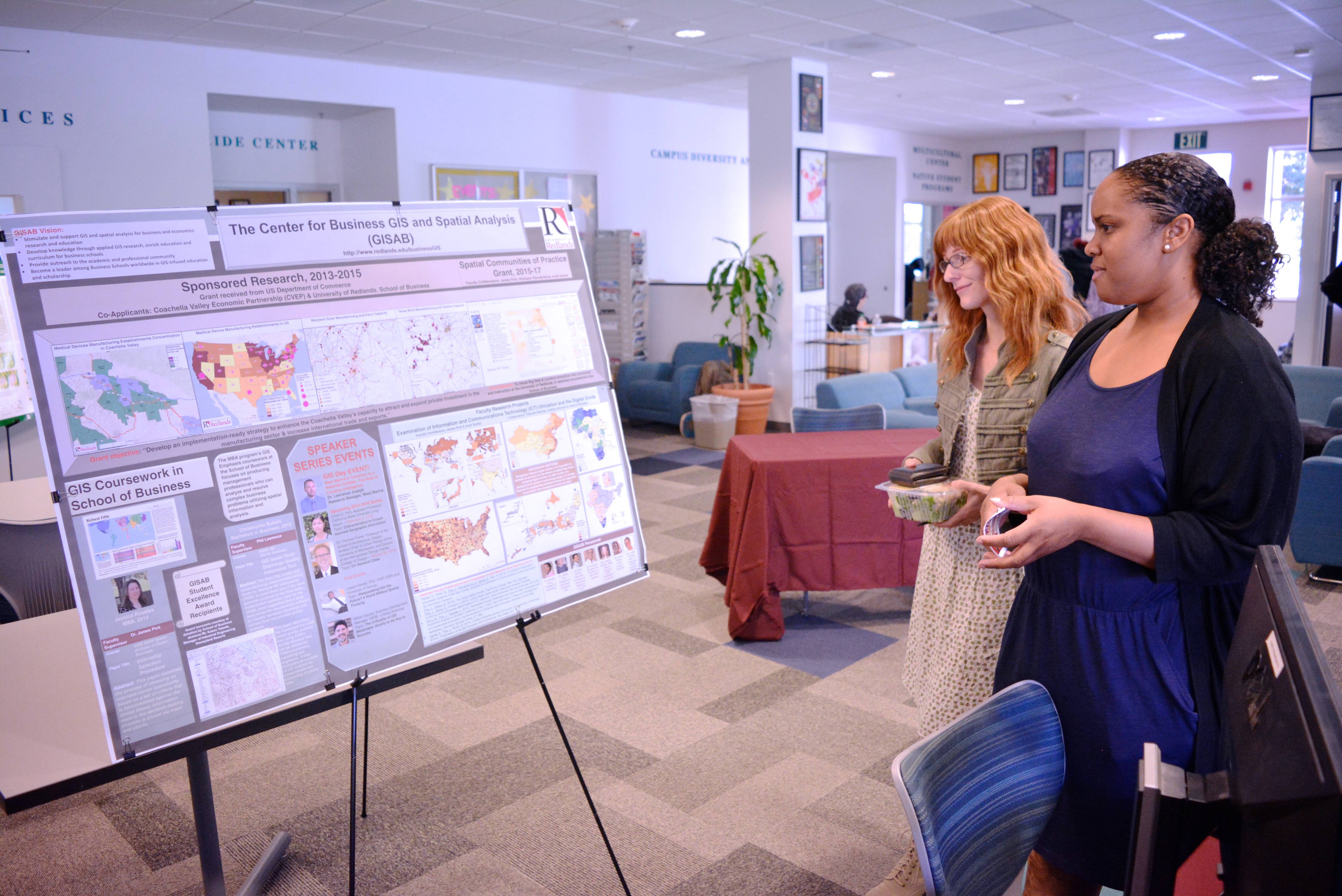 a group of women looking at a display board