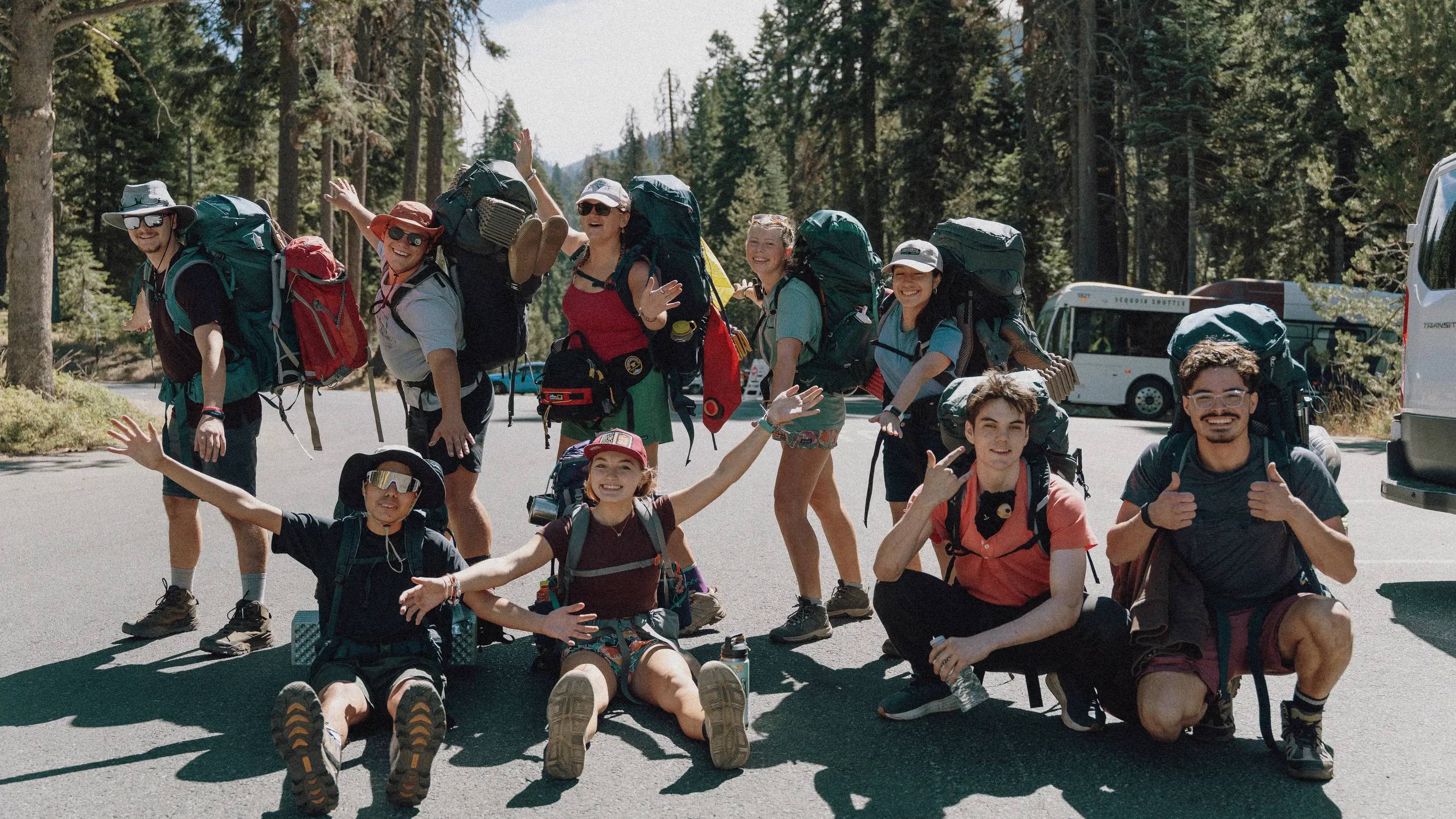 a group of people with backpacks posing for a photo