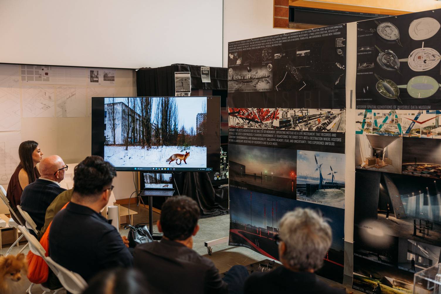 a group of people looking at a screen