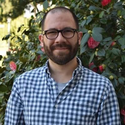 a person with a beard and glasses