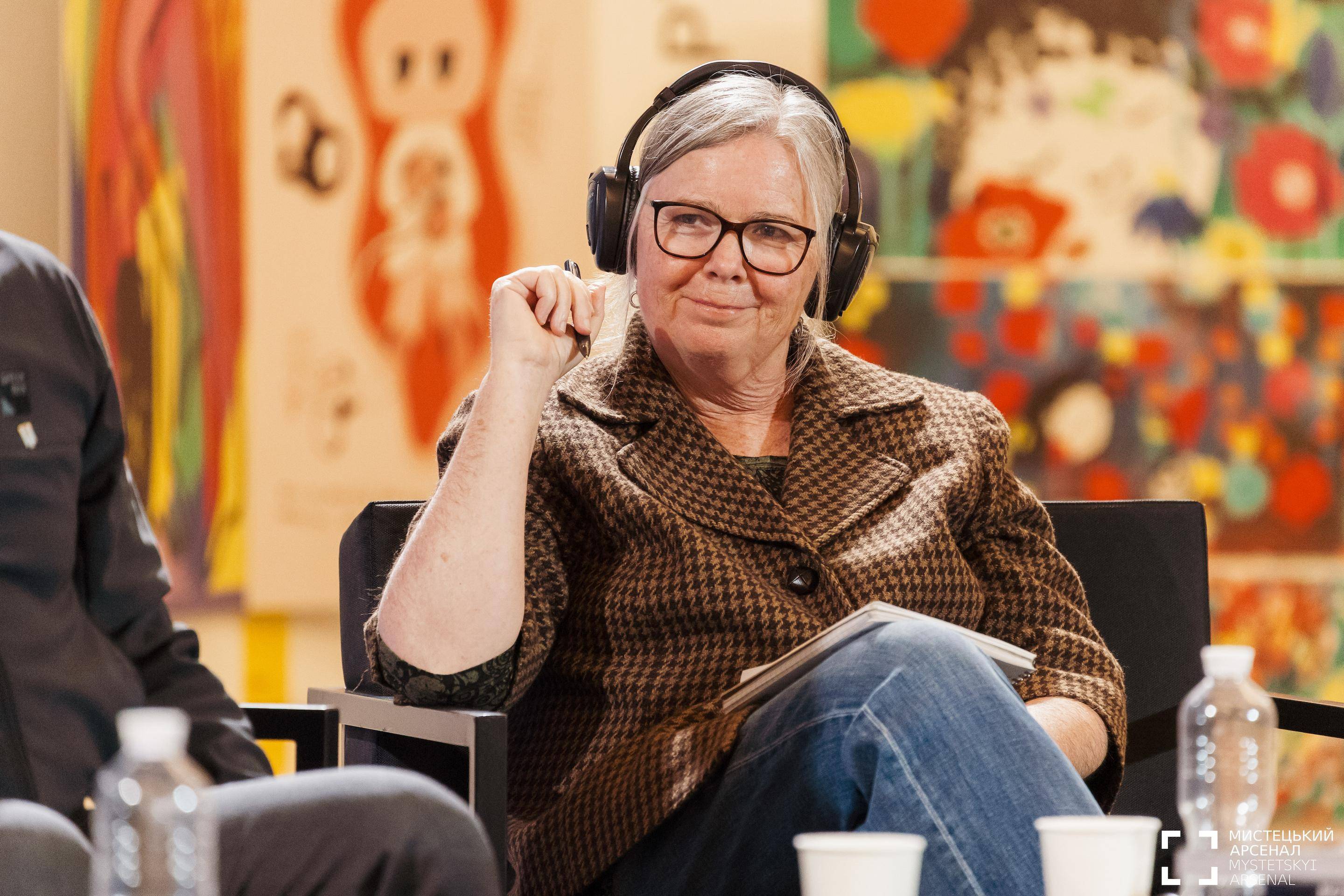 a person wearing headphones and sitting in a chair
