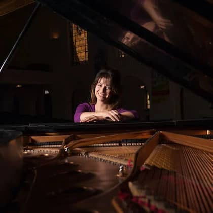 a person leaning on a piano