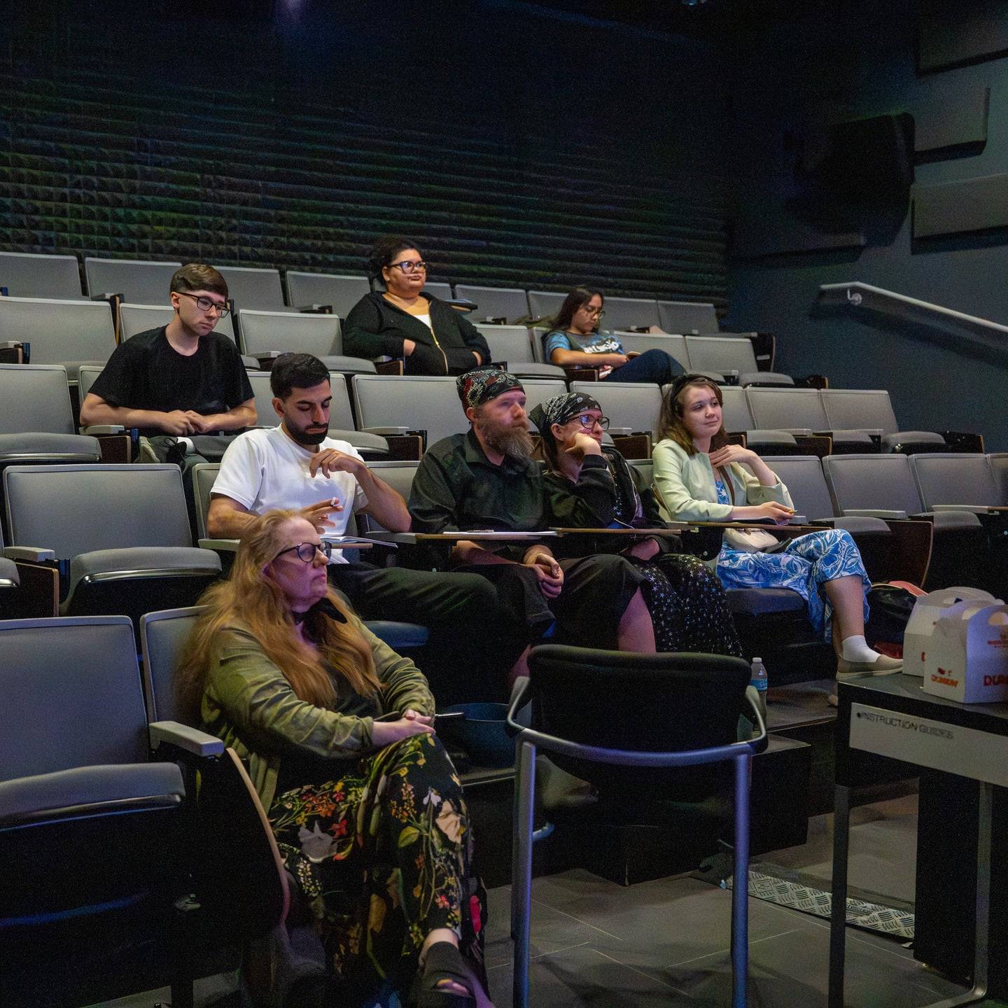 a group of people sitting in an auditorium