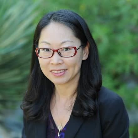 a person wearing glasses and a black jacket