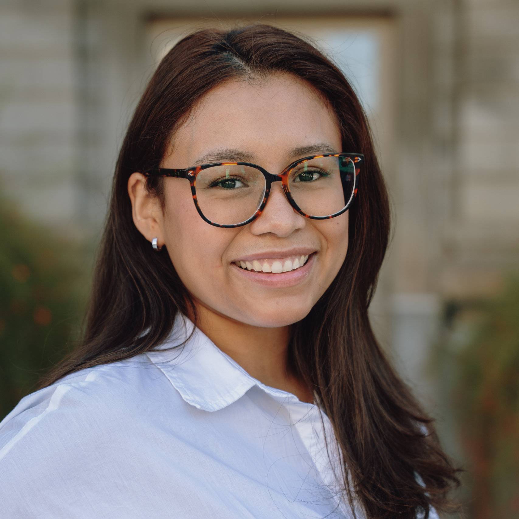 a person wearing glasses smiling
