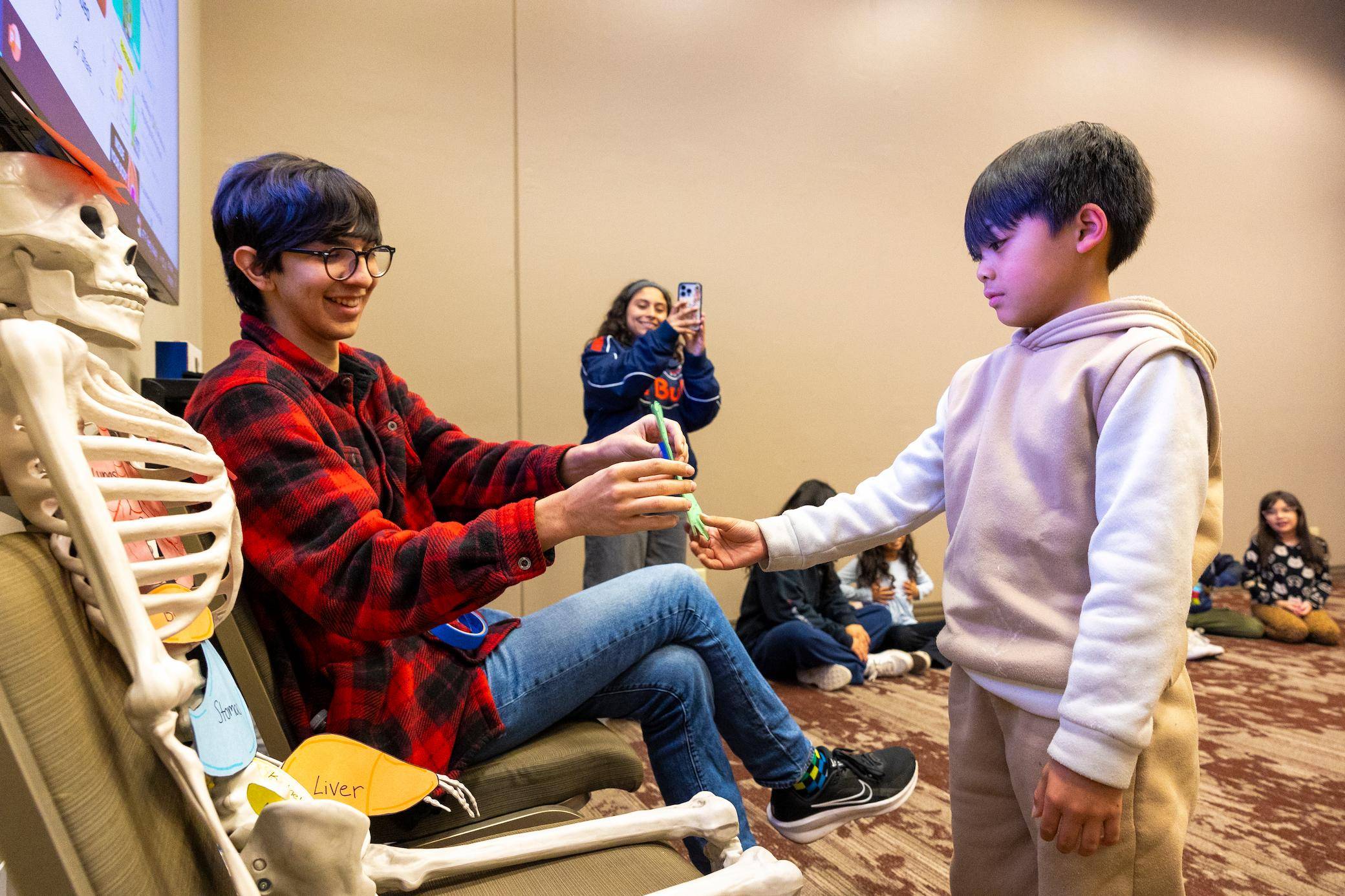 a child giving a toothbrush to a child