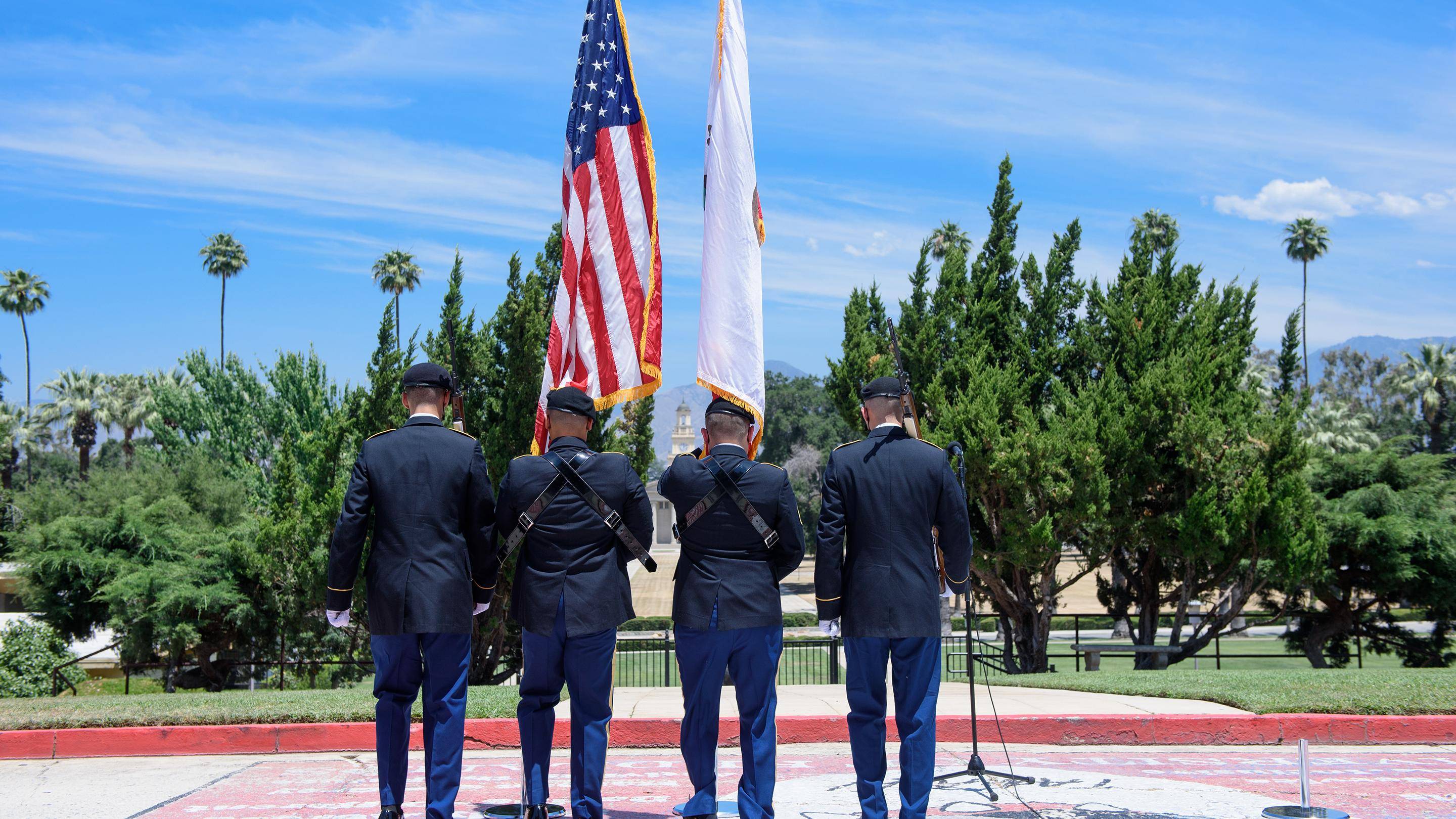 a group of men in uniform holding flags