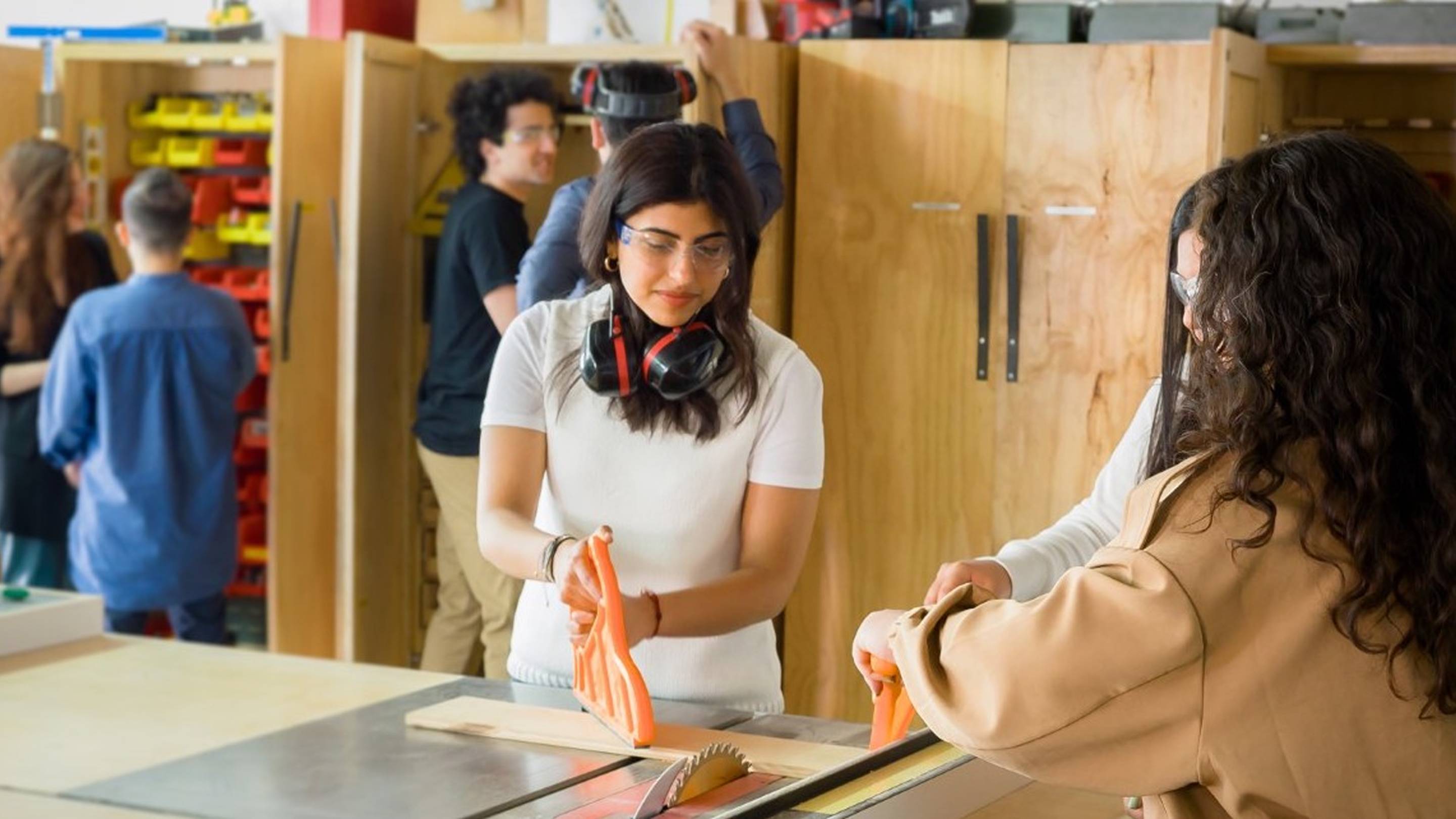 a person using a saw to cut wood