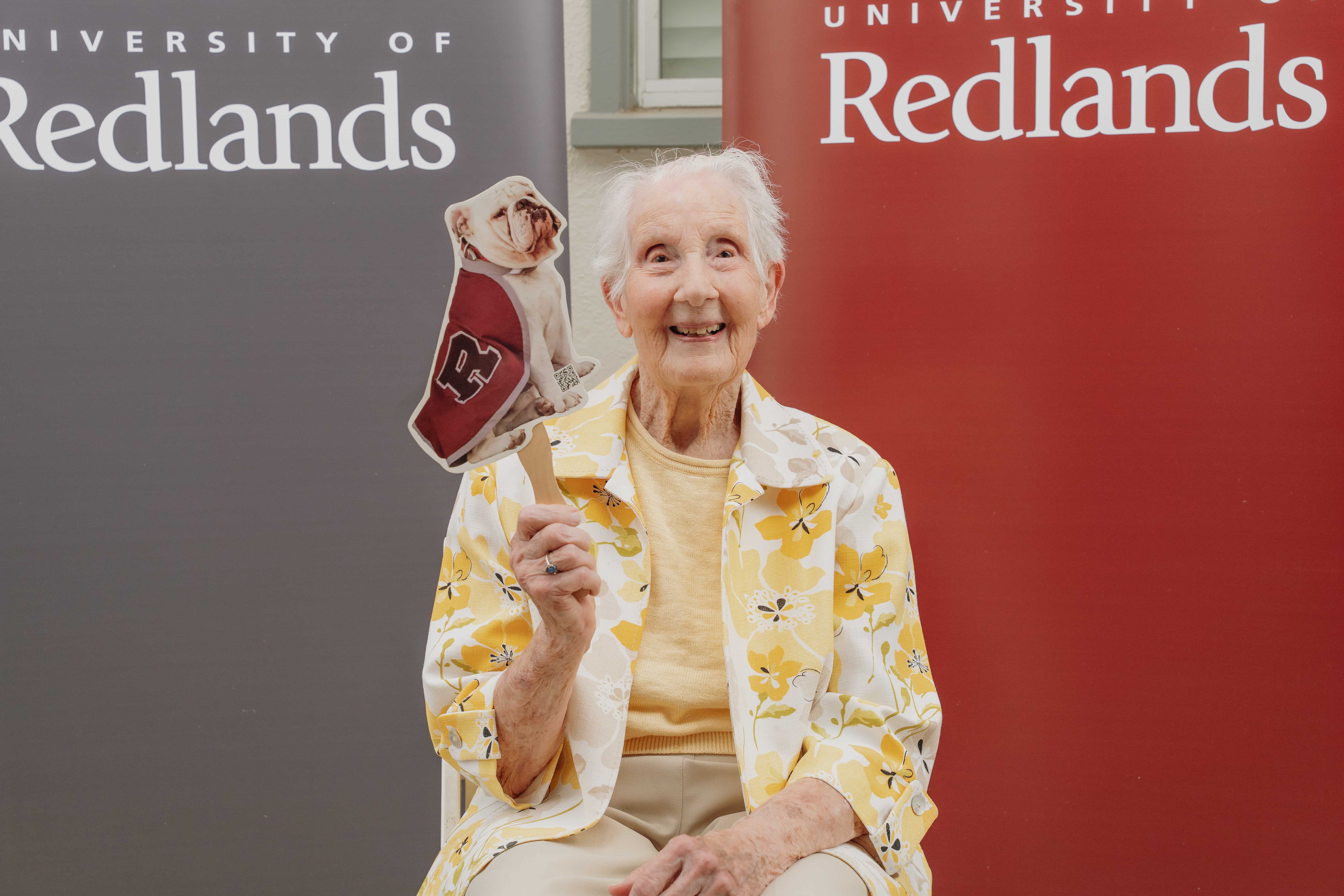 an old person holding a paper puppet