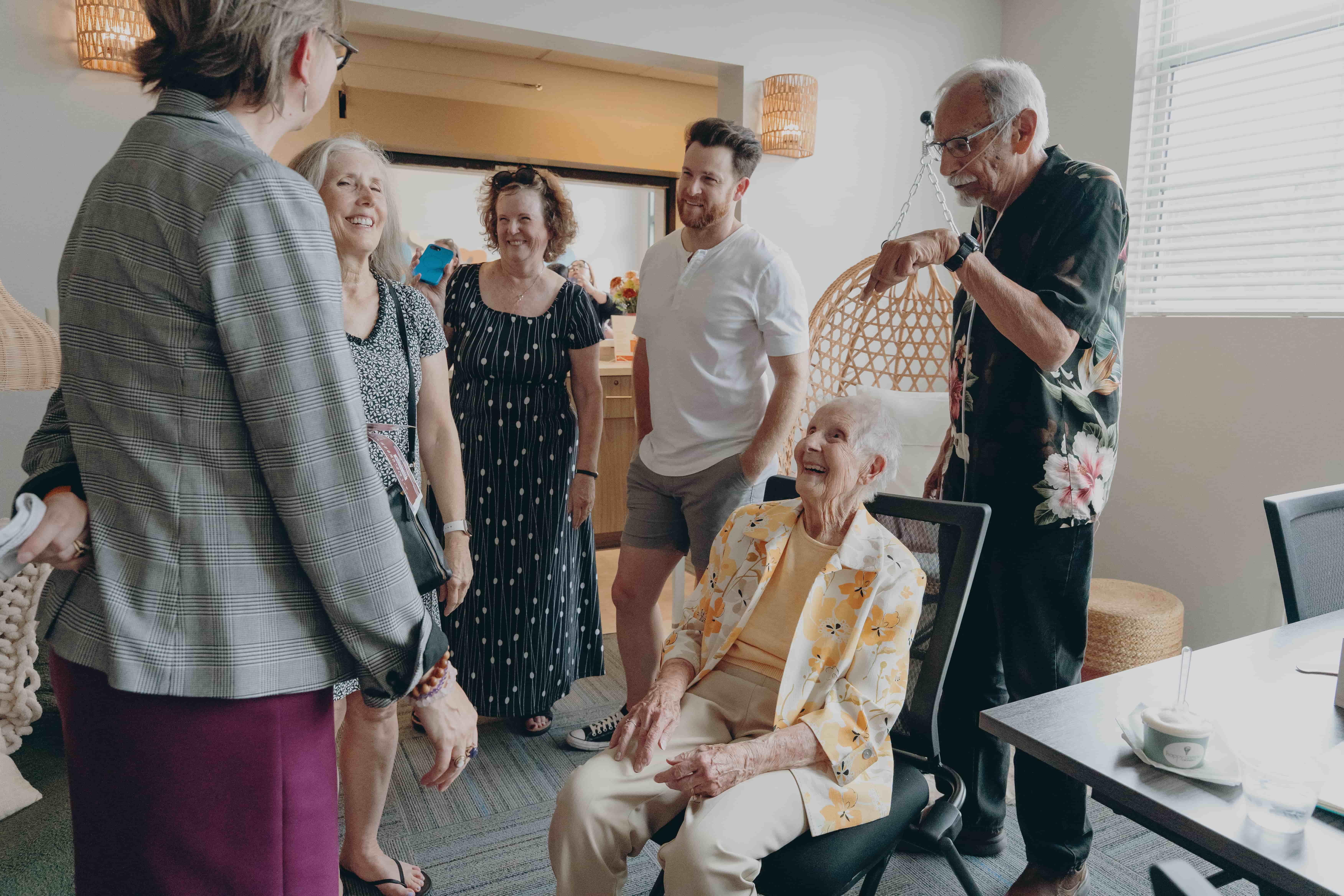 a group of people around an old person