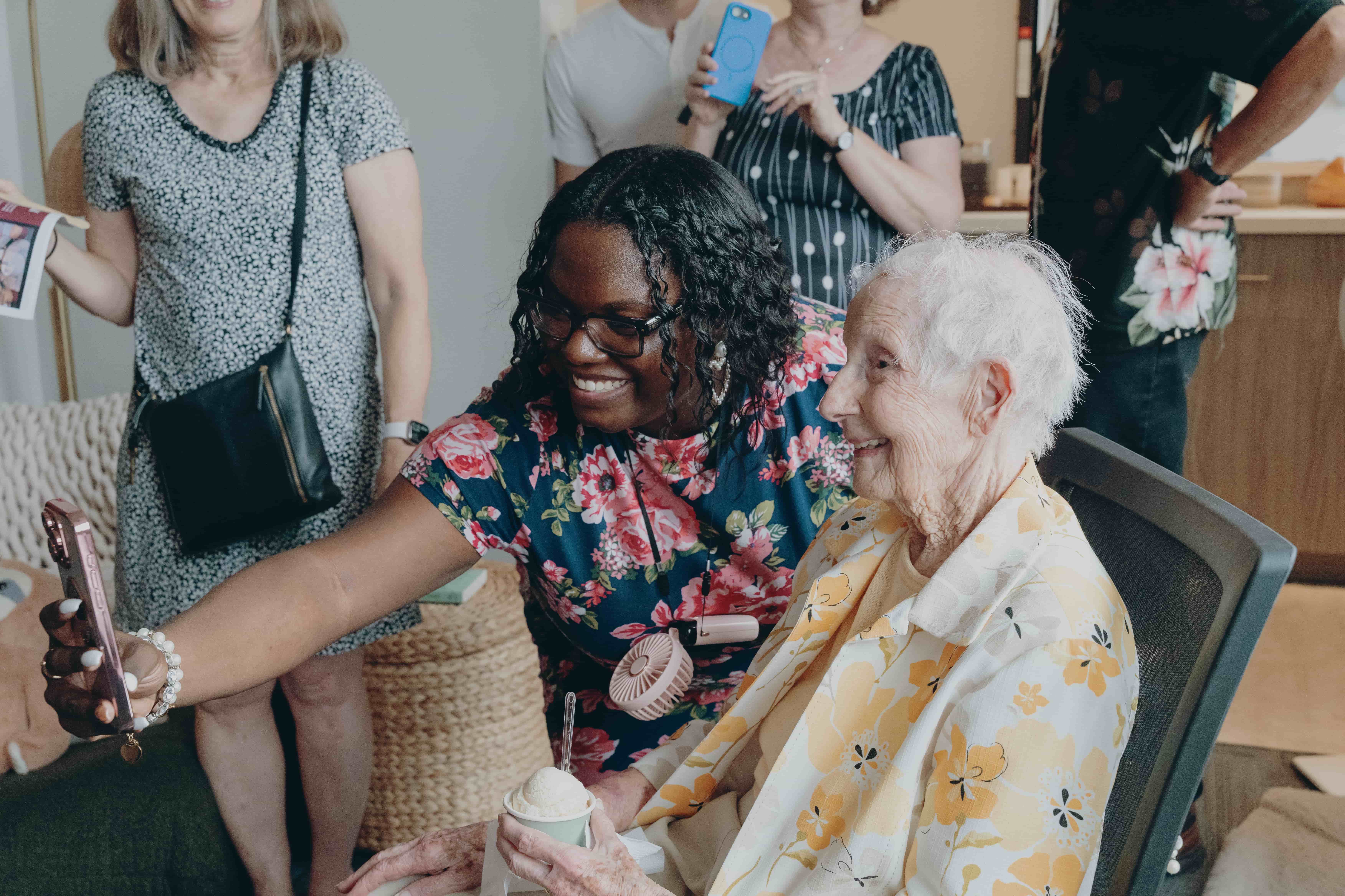 a person smiling at an elderly person