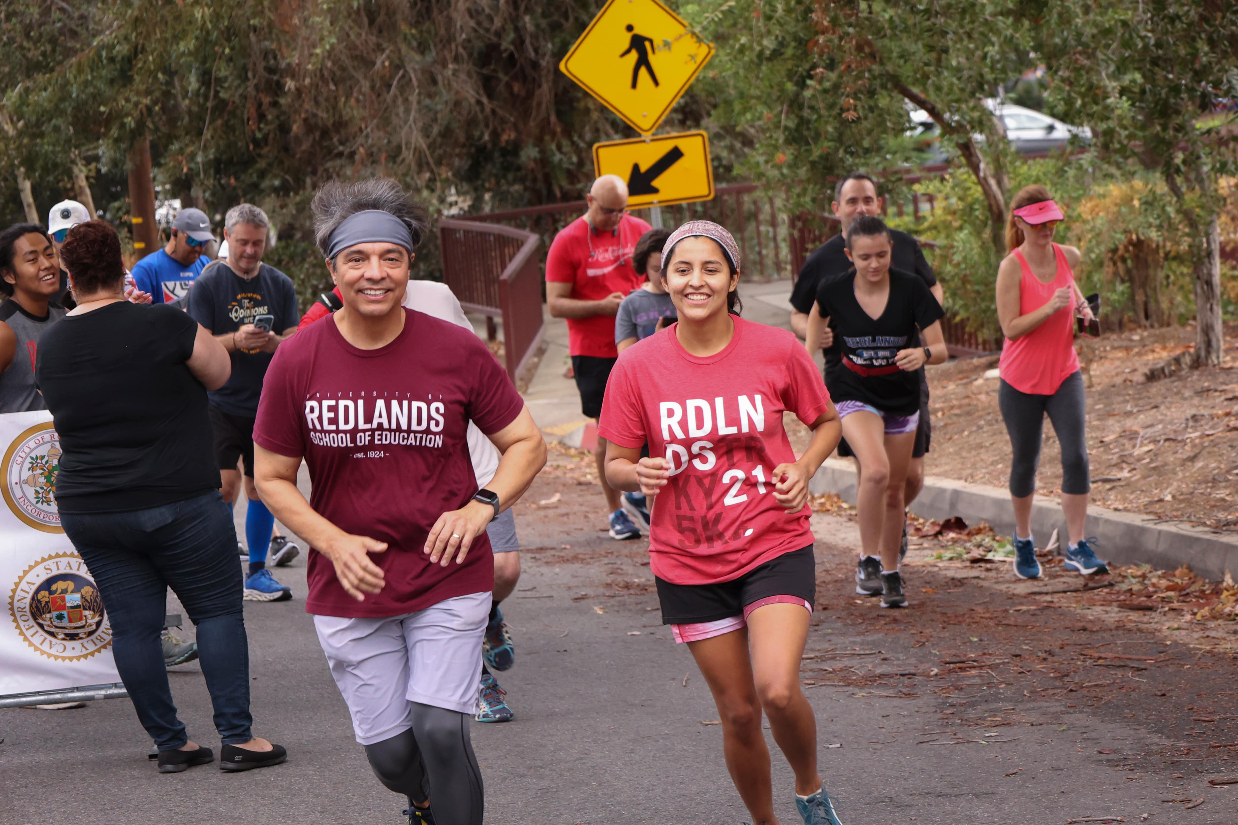 a group of people running on a street