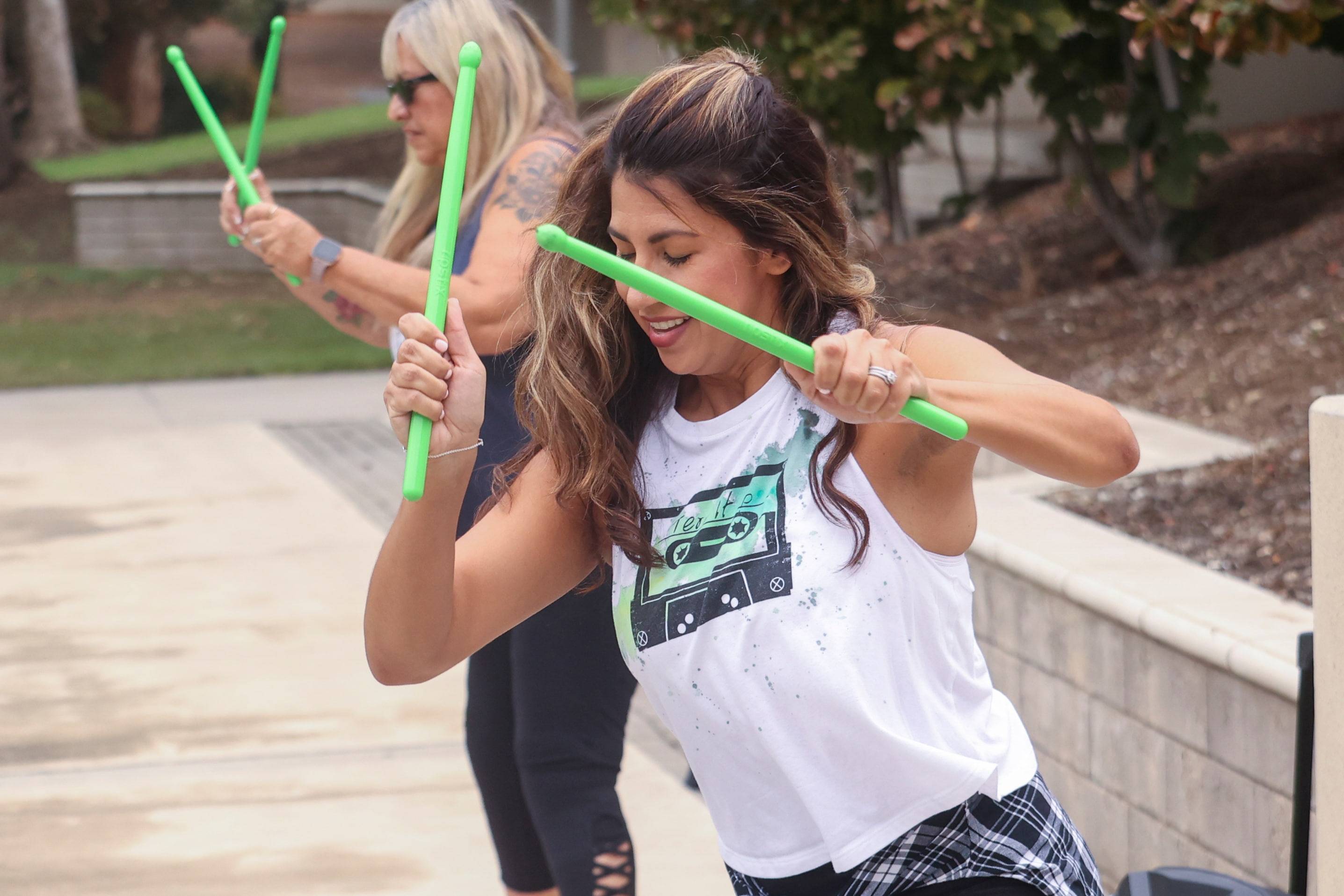 a group of women holding sticks