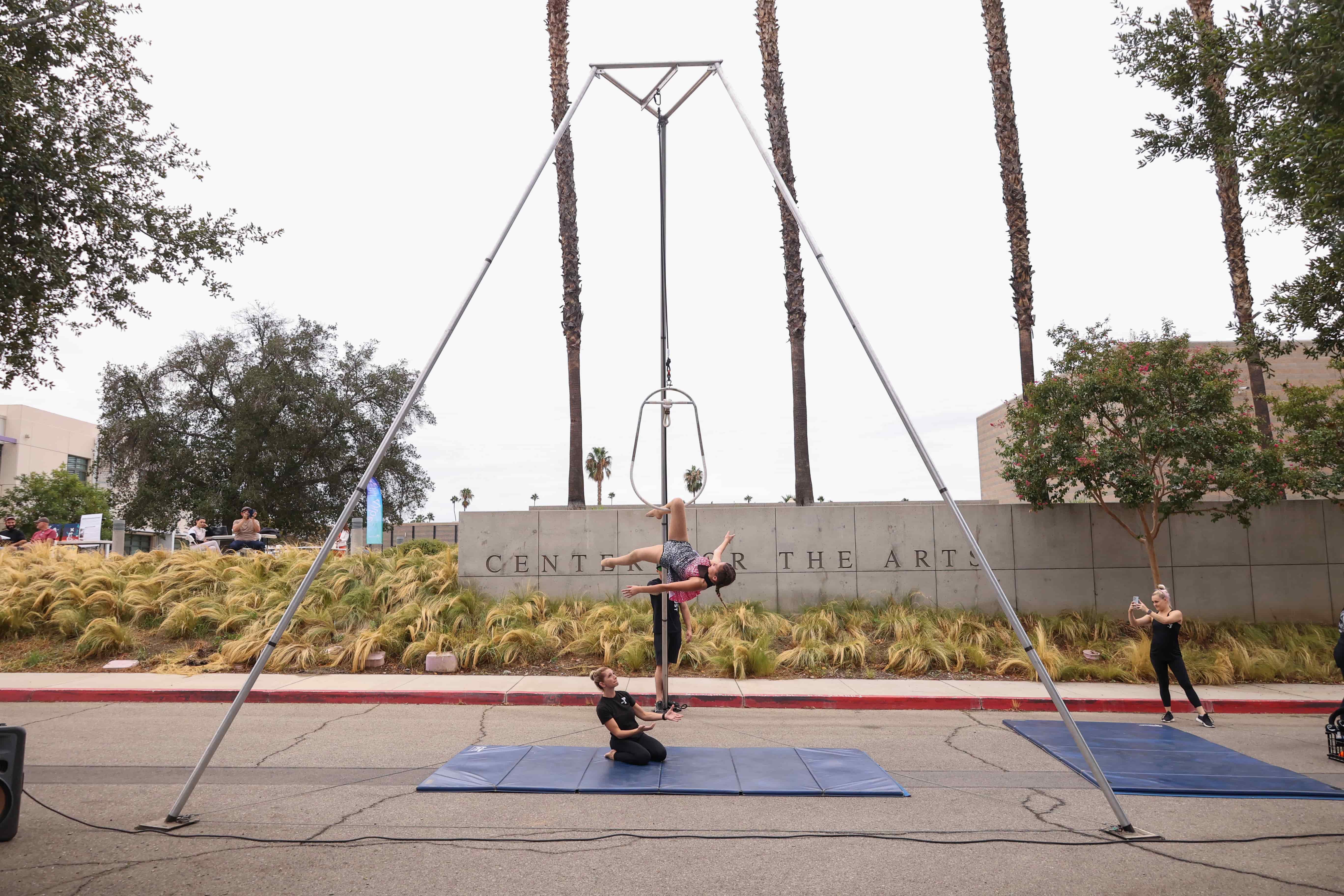 a person and person doing acrobatics on mats