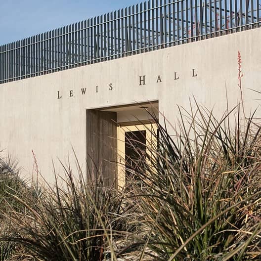 a building with a fence and grass