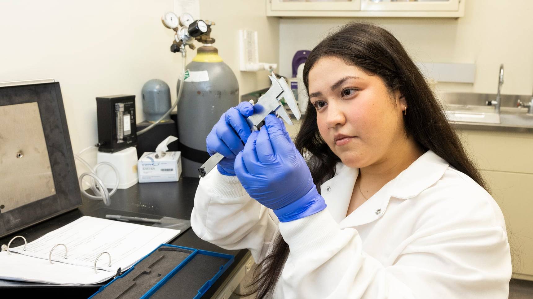 a person holding a caliper