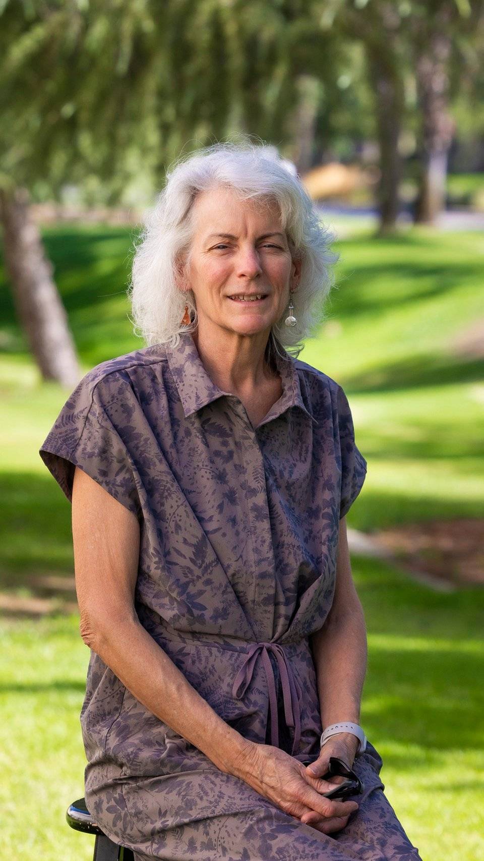 a person with white hair and a purple dress