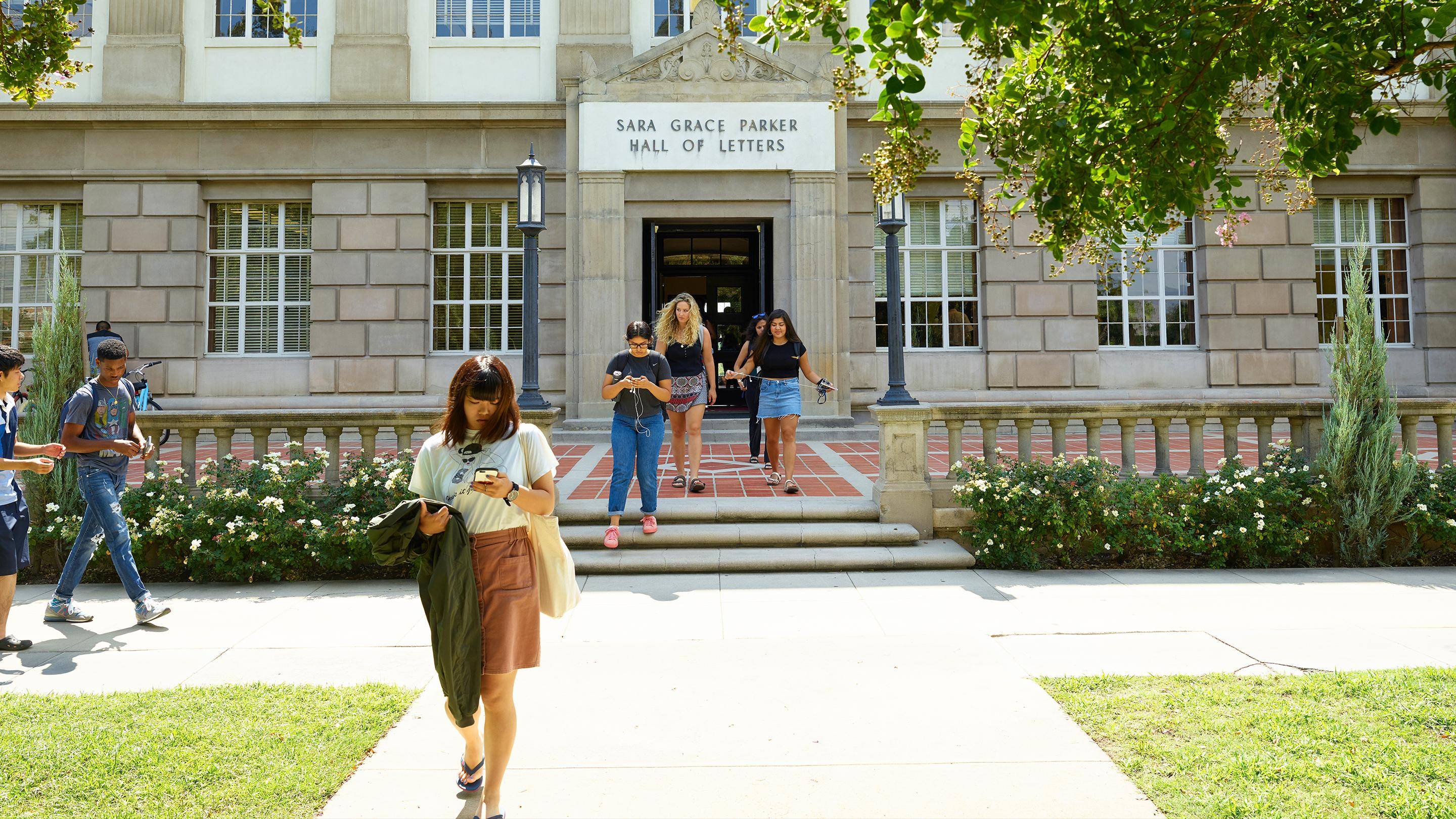 a group of people walking in front of a building